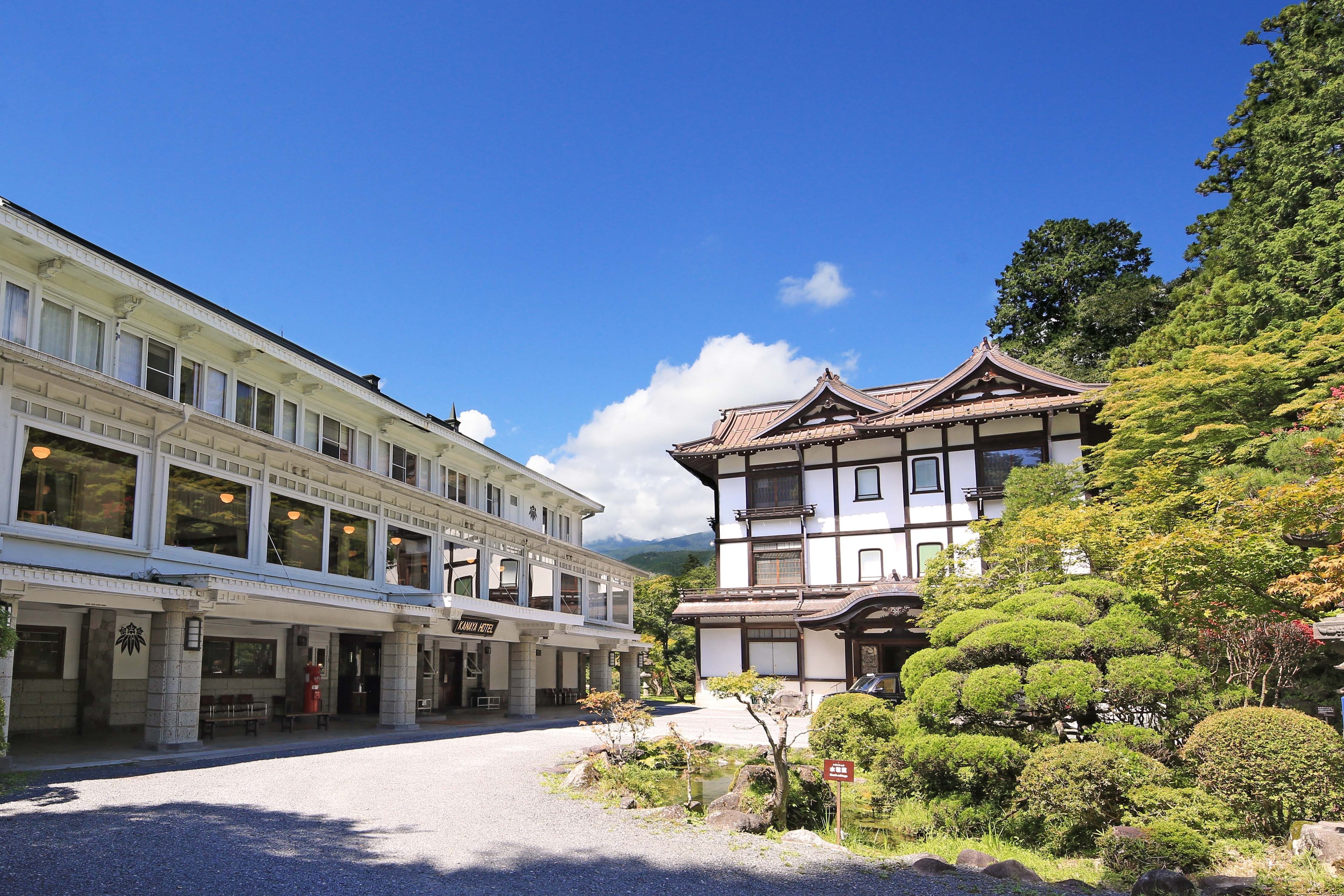 Hotel courtyard and historic facades beneath a blue sky at Nikko Kanaya Hotel, Nikko, Japan