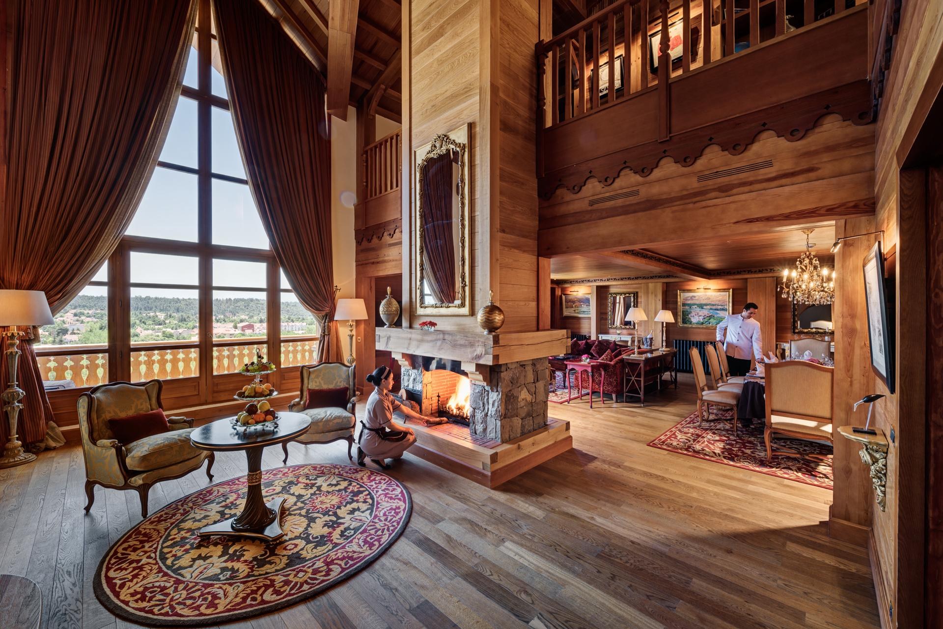 Double-height timber lounge and stone fireplace at Michlifen Resort & Golf