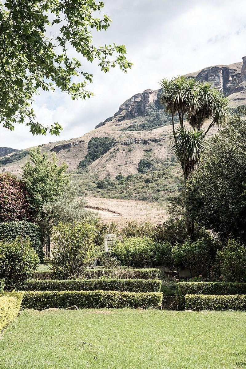 Garden lawn and pergola with a mountain view, Cleopatra Mountain Farmhouse, Drakensberg, KwaZulu-Natal, South Africa