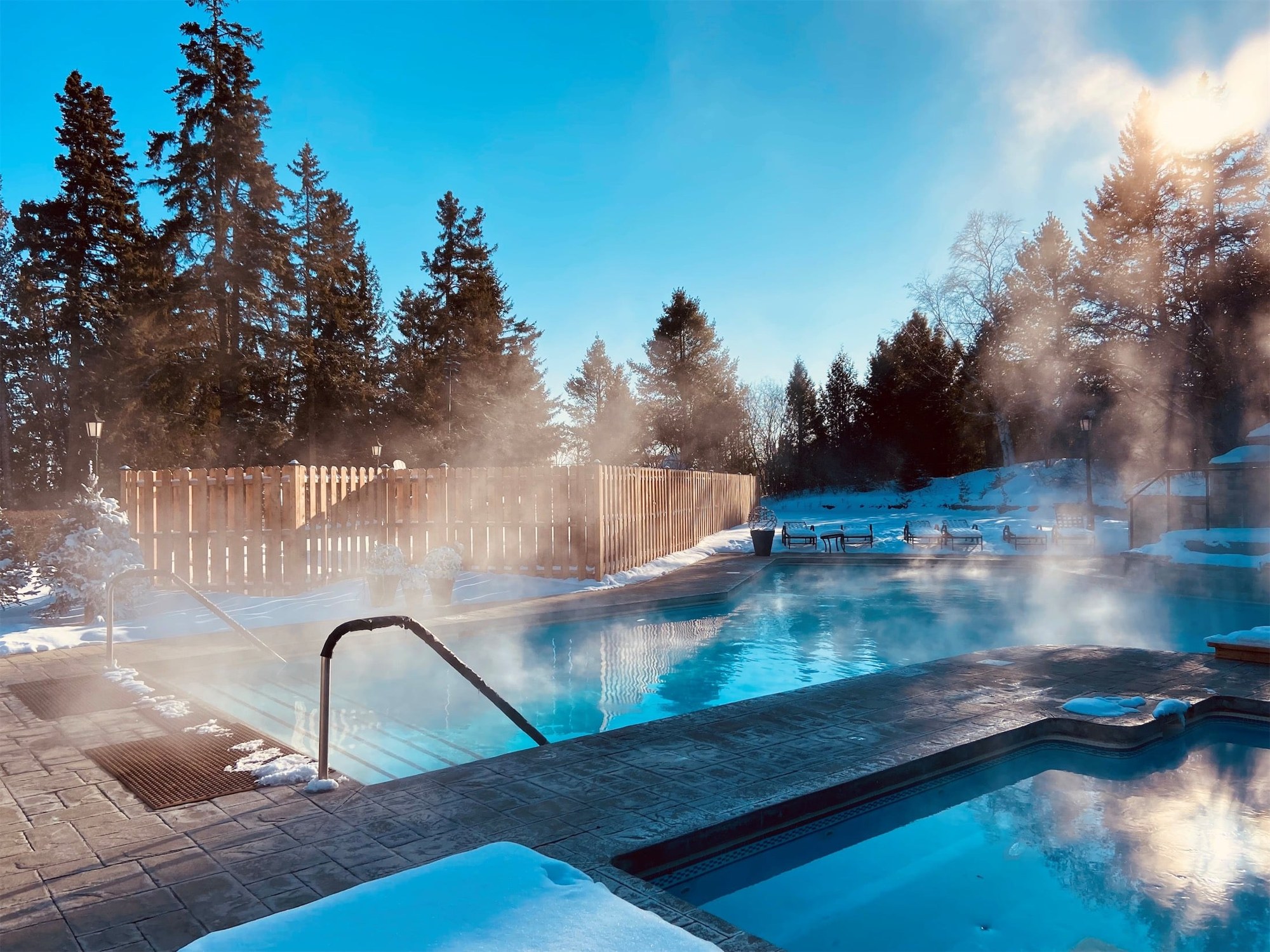 Steaming outdoor pool surrounded by snow at Fairmont Le Manoir Richelieu