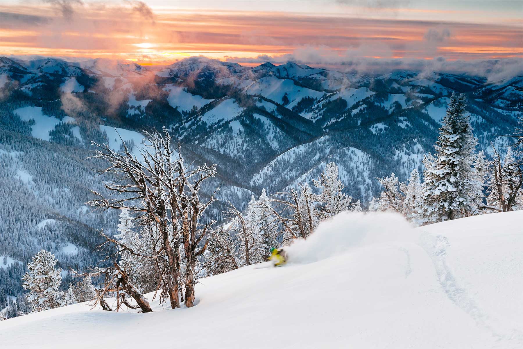 Backcountry skiing beneath the Tetons at sunset, near Caldera House, Teton Village, USA