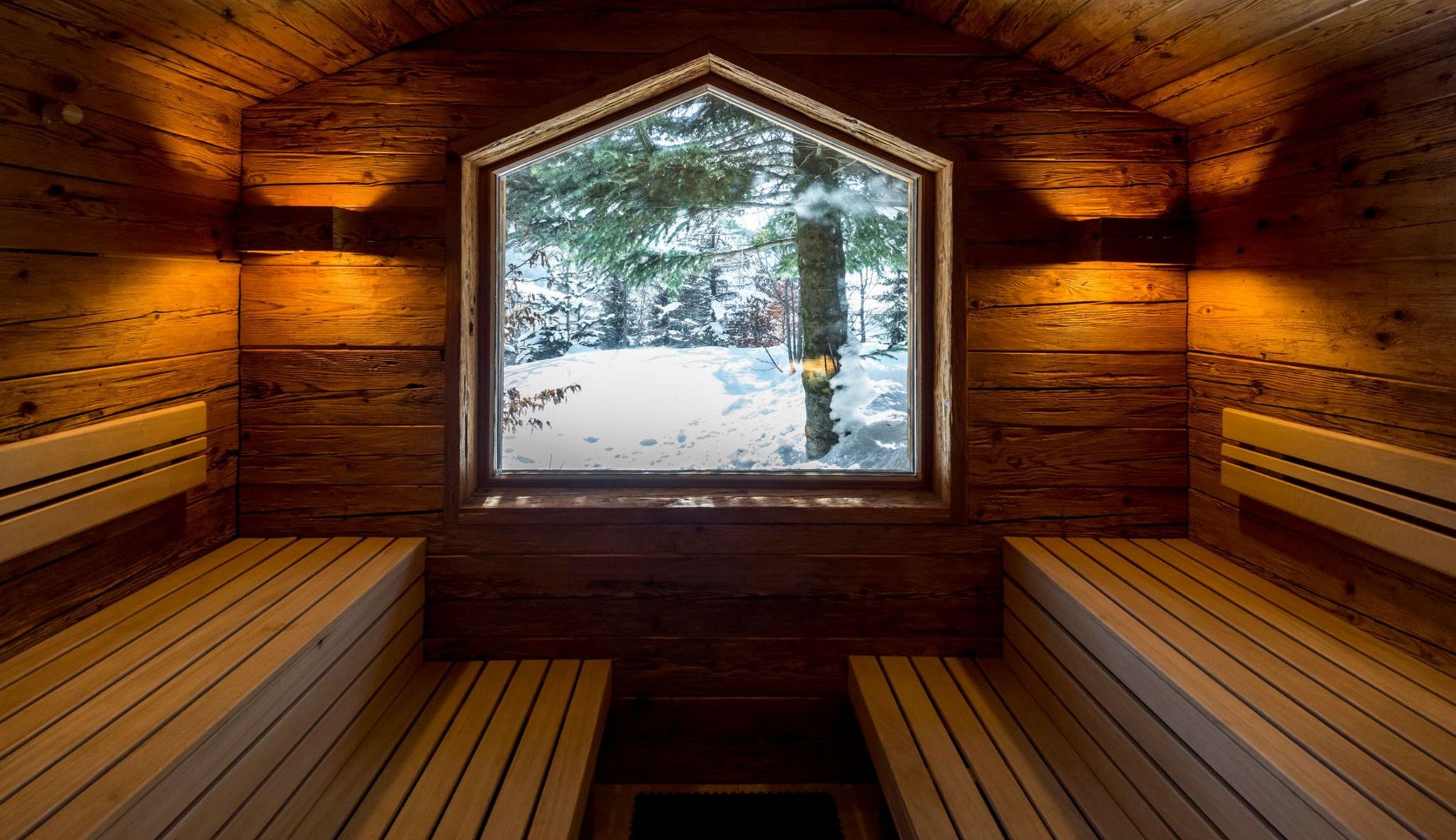 Timber sauna overlooking snow-covered trees, Hotel Tannenhof, St. Anton am Arlberg, Austria
