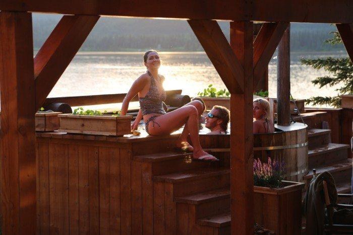 Outdoor wooden hot tub overlooking Judd Lake, Tordrillo Mountain Lodge, Alaska, USA