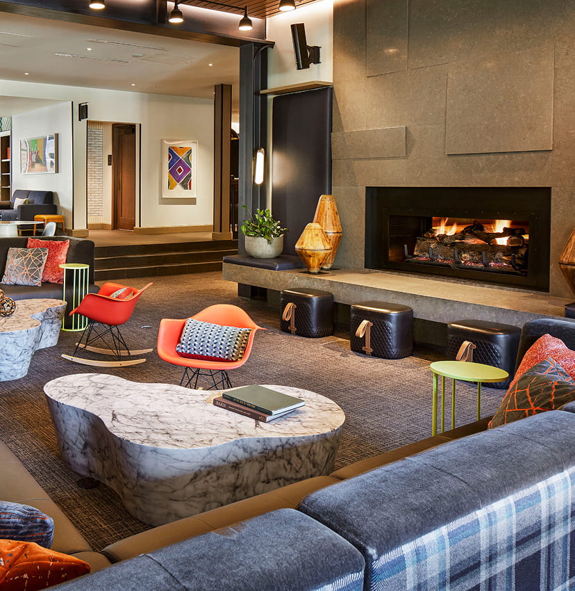 Fireplace and colourful lounge seating at Limelight Hotel Snowmass.