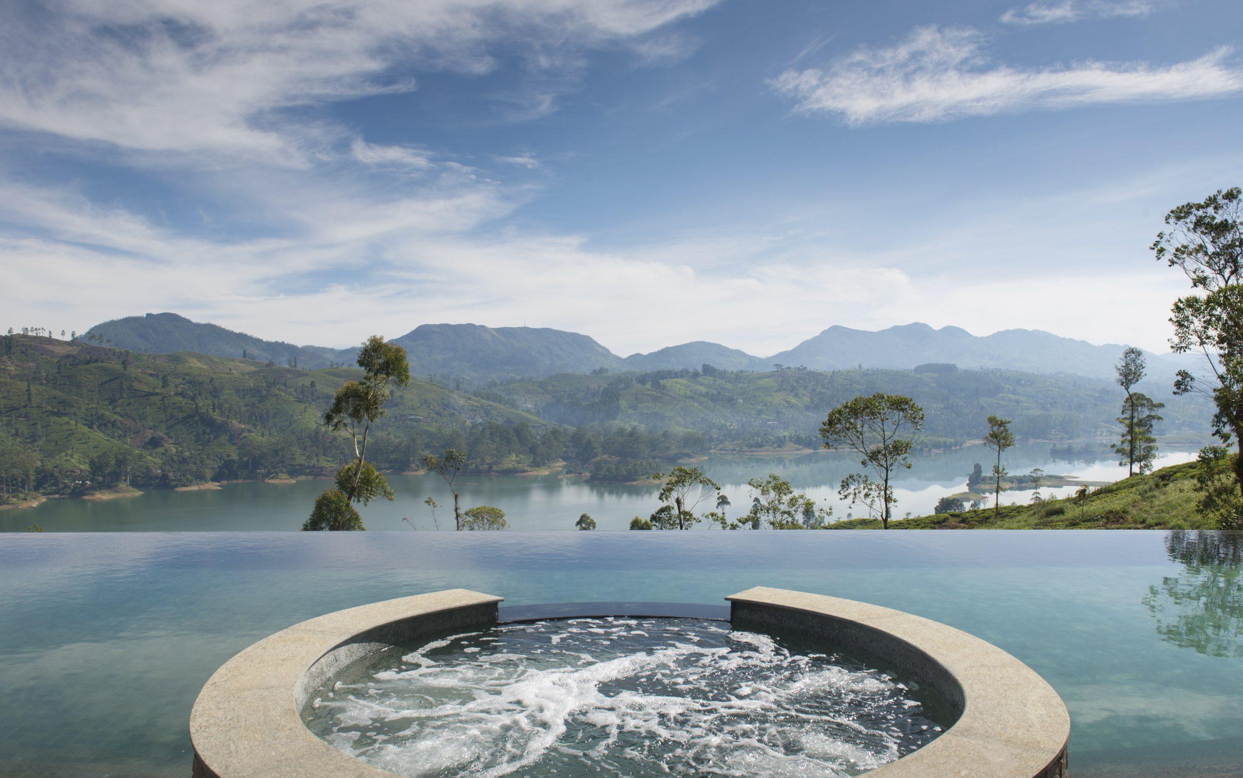 Circular hot tub overlooking a lake and distant mountains, Ceylon Tea Trails, Hatton, Sri Lanka