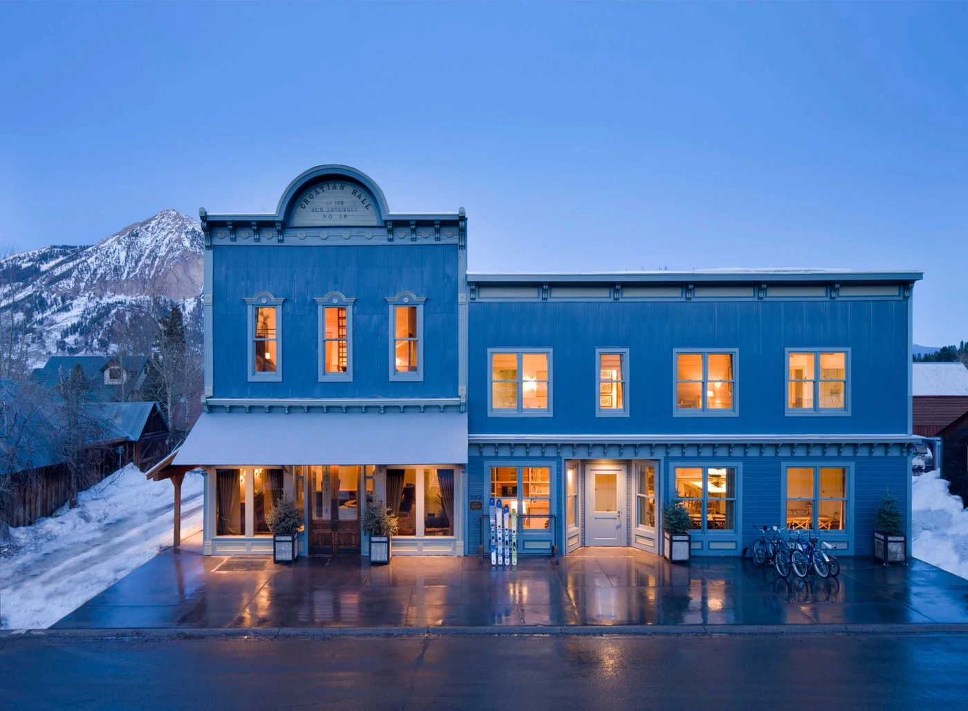 Historic blue exterior of Eleven Scarp Ridge Lodge at dusk, Crested Butte, USA
