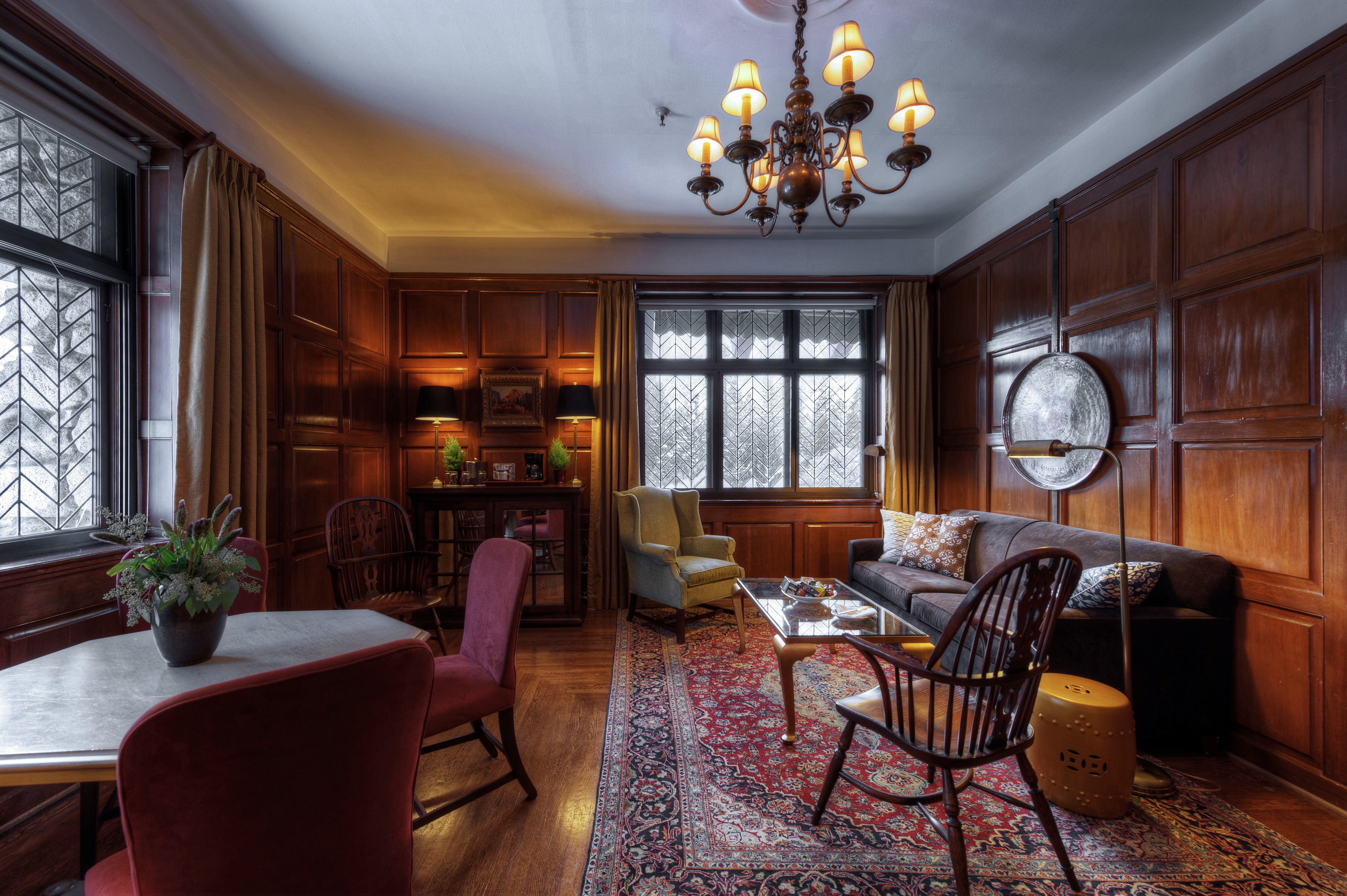 Suite sitting room with fireplace and large windows at The Ahwahnee, Yosemite National Park, USA
