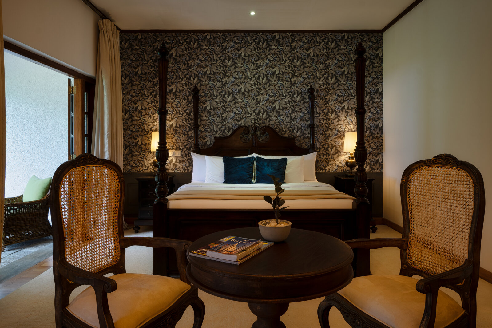 Four-poster bed and sitting area in the Sir Thomas Lipton Suite at Thotalagala, Sri Lanka