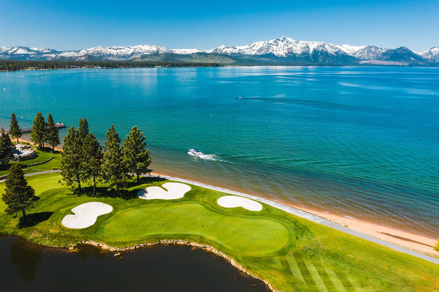 Lake Tahoe shoreline and golf course with mountains across the water, Stateline, USA