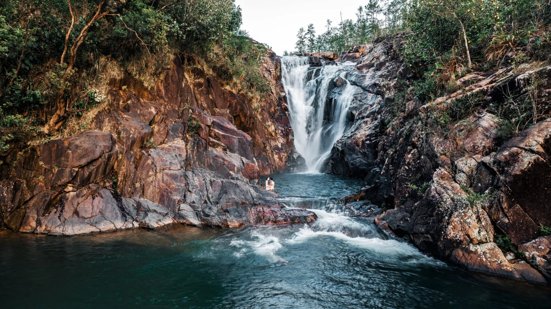 Waterfall cascading into a rocky jungle pool, Blancaneaux Lodge, Mountain Pine Ridge, Cayo, Belize