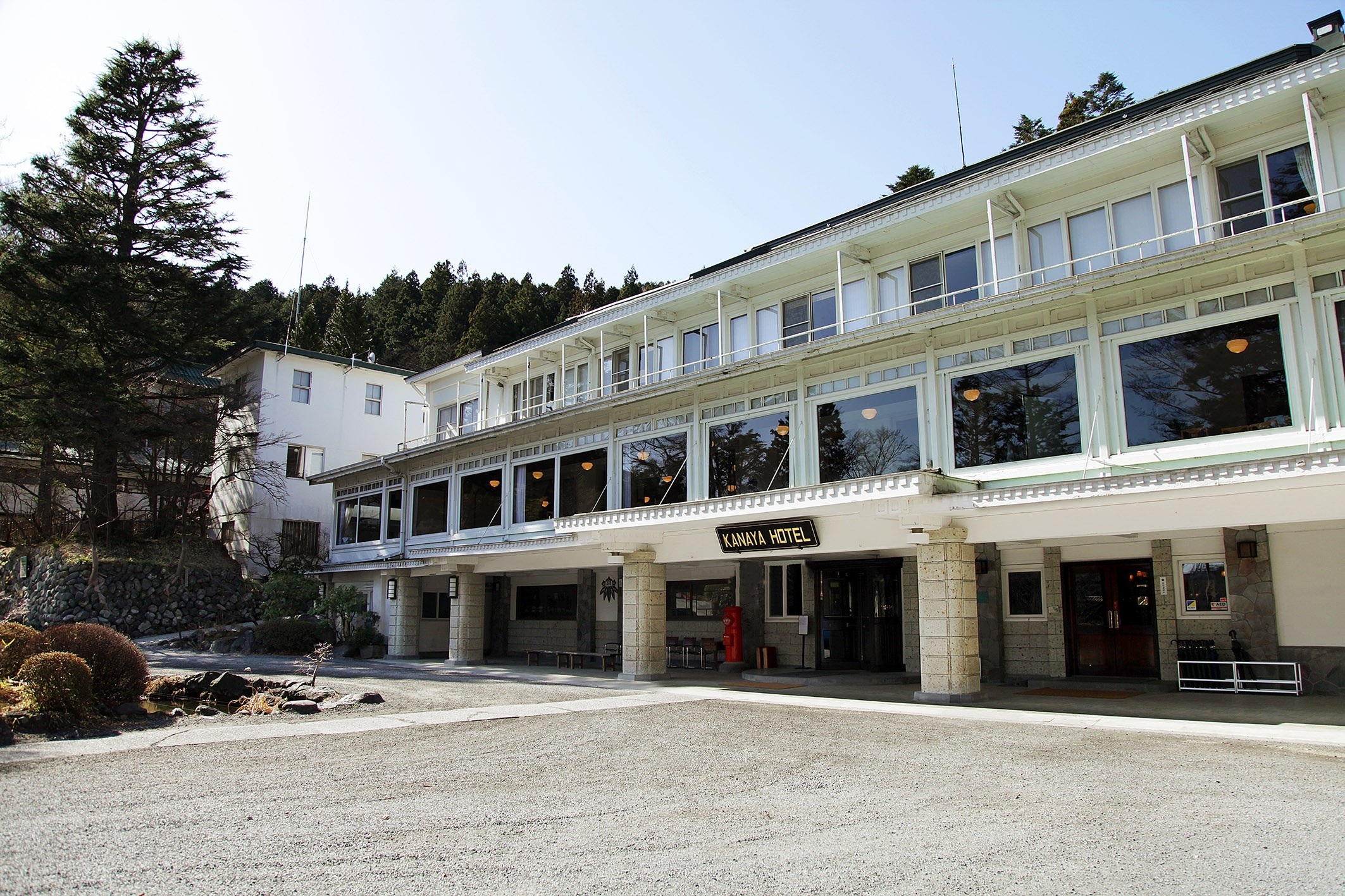 Hotel entrance and white facade in daylight at Nikko Kanaya Hotel, Nikko, Japan