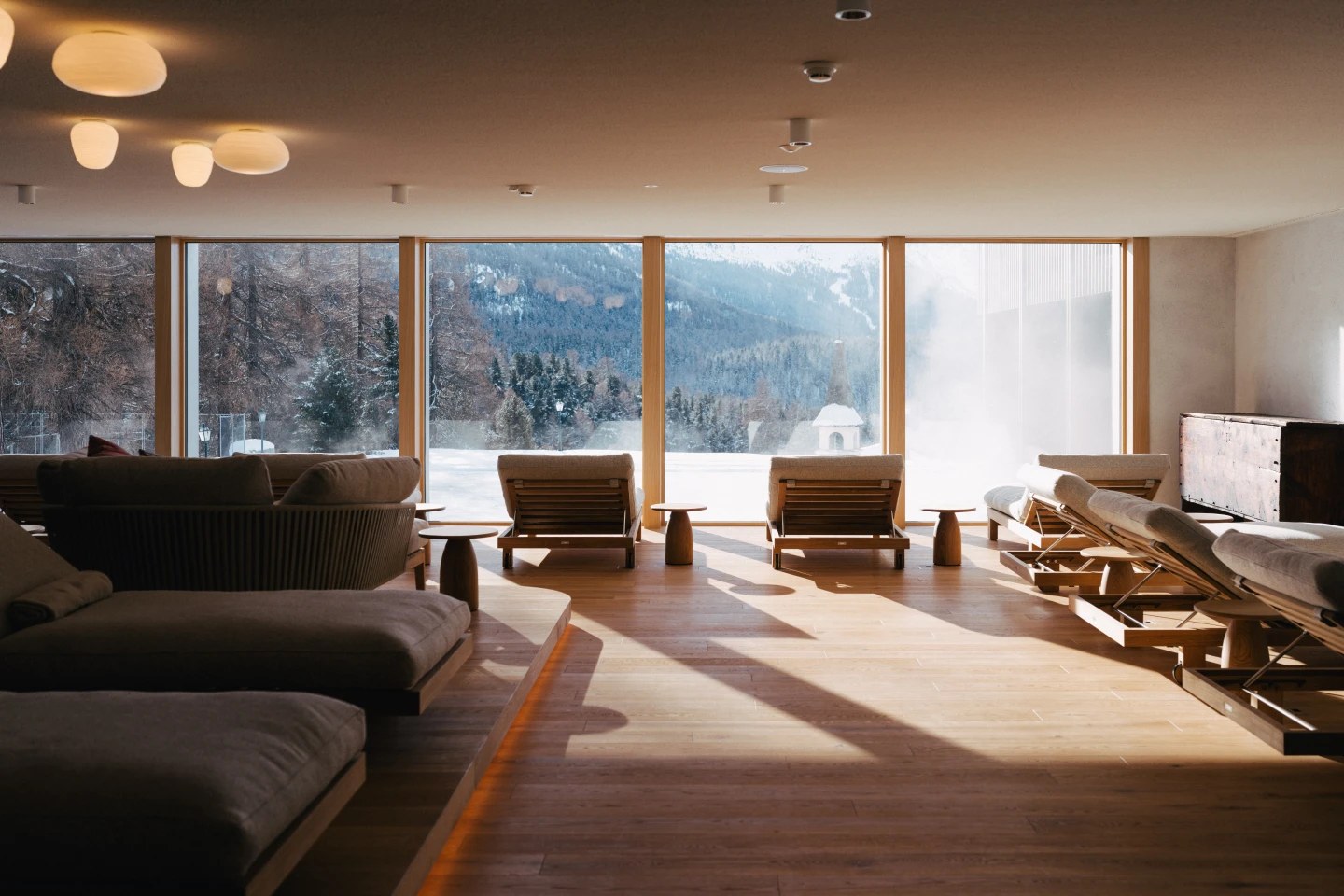 Spa relaxation lounge with armchairs facing mountain views, Suvretta House, St. Moritz, Switzerland
