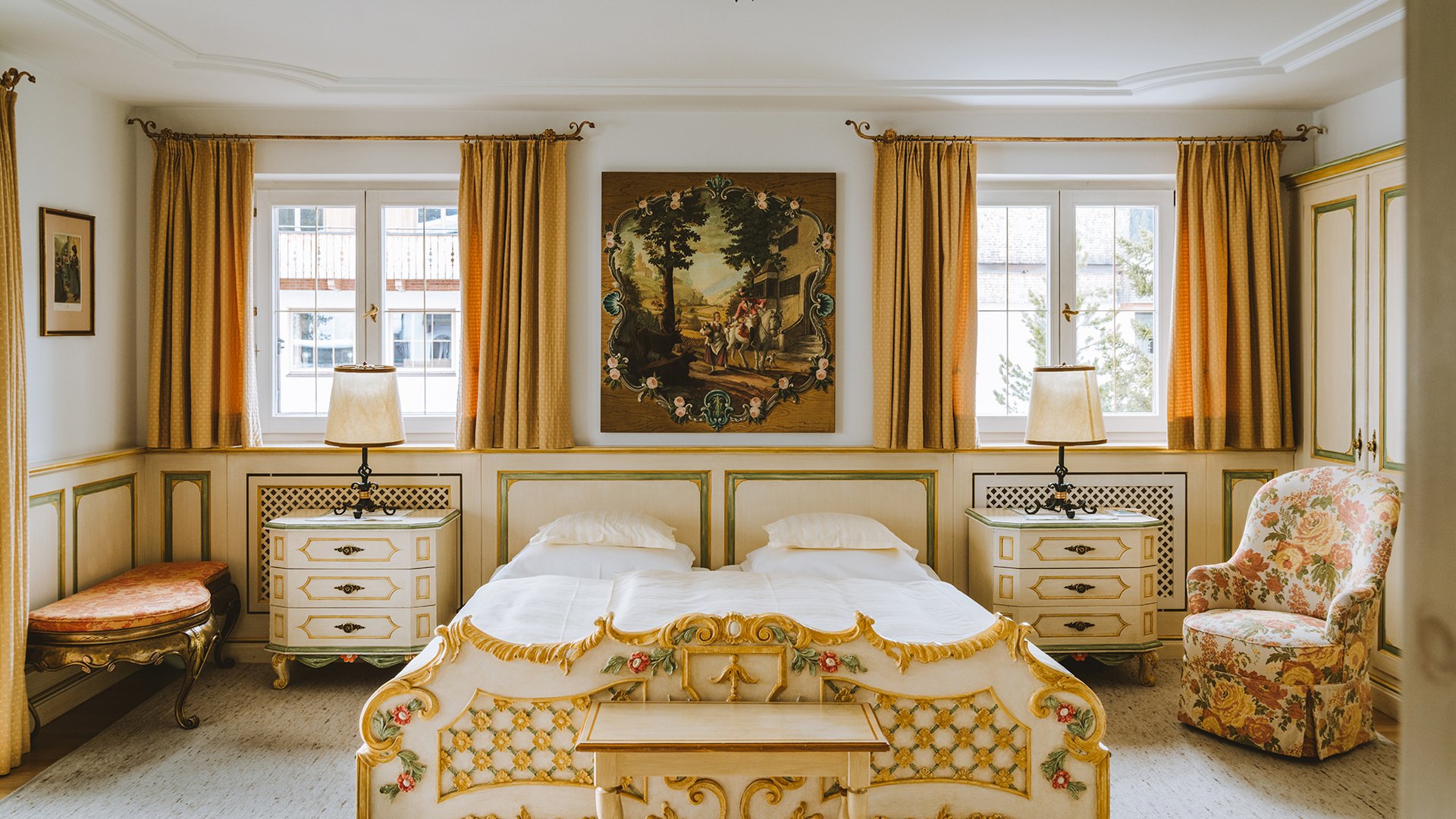 Individually furnished bedroom with patterned fabrics and framed artwork at Post Lech Arlberg, Lech, Austria