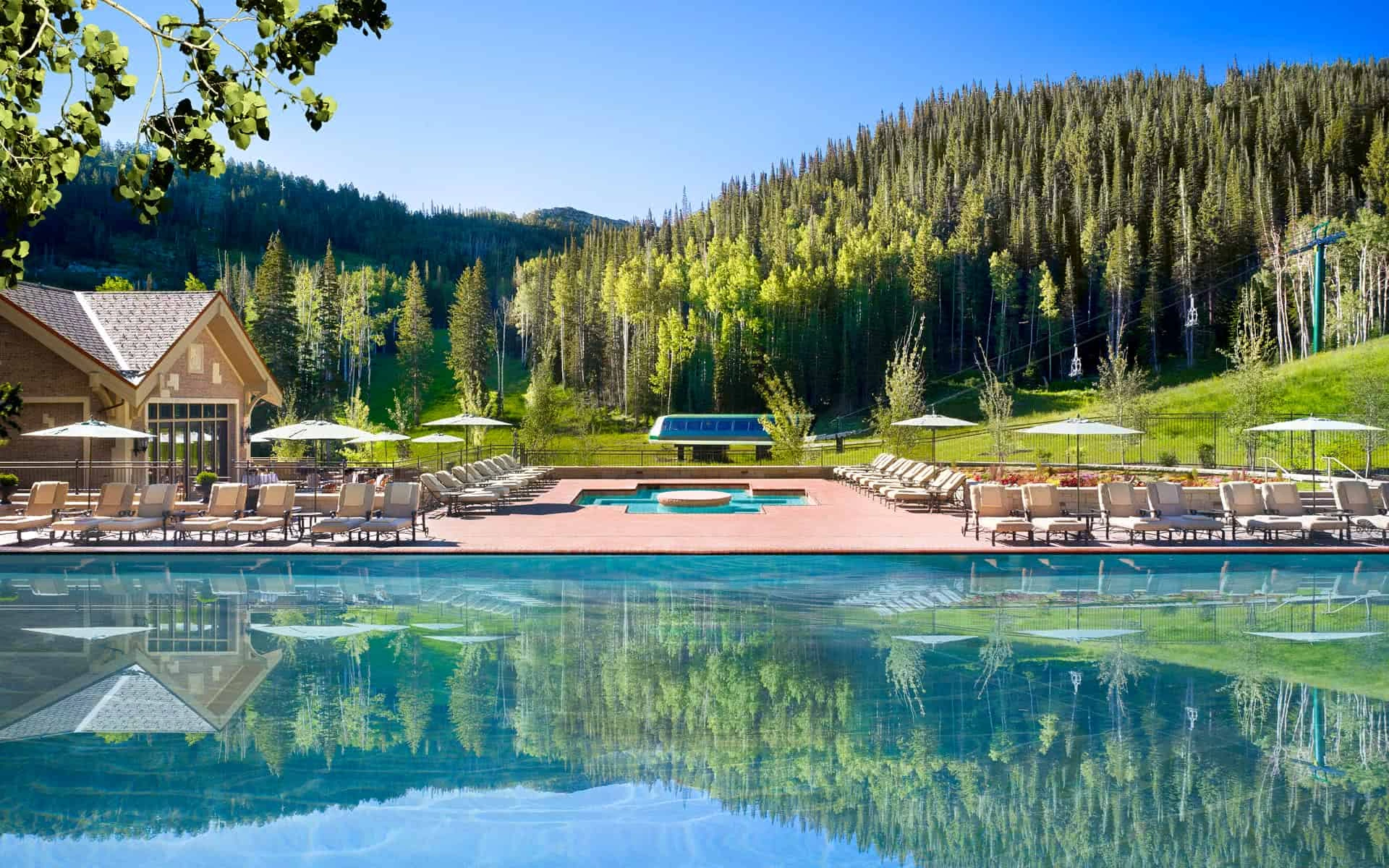 Outdoor swimming pool beside a forested hillside at Montage Deer Valley, Utah, USA