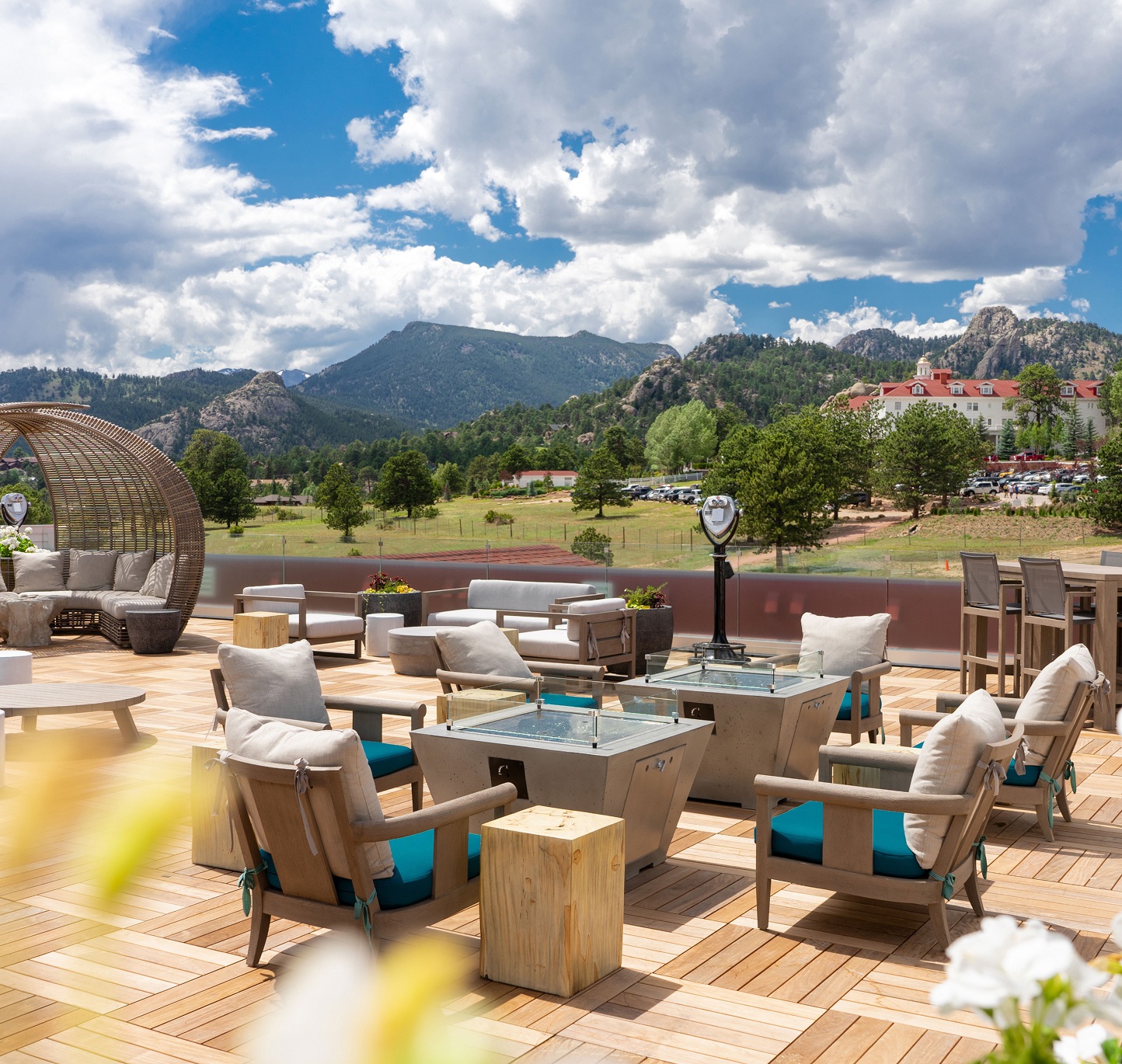 Outdoor patio with seating overlooking mountains at The Stanley Hotel, Estes Park, USA