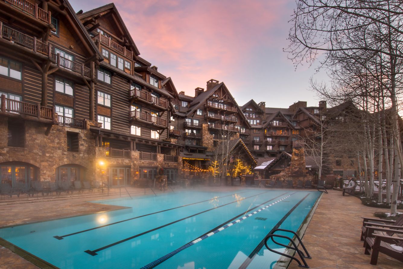 Steam rising from the outdoor swimming pool beside The Ritz-Carlton, Bachelor Gulch, at sunset in winter.