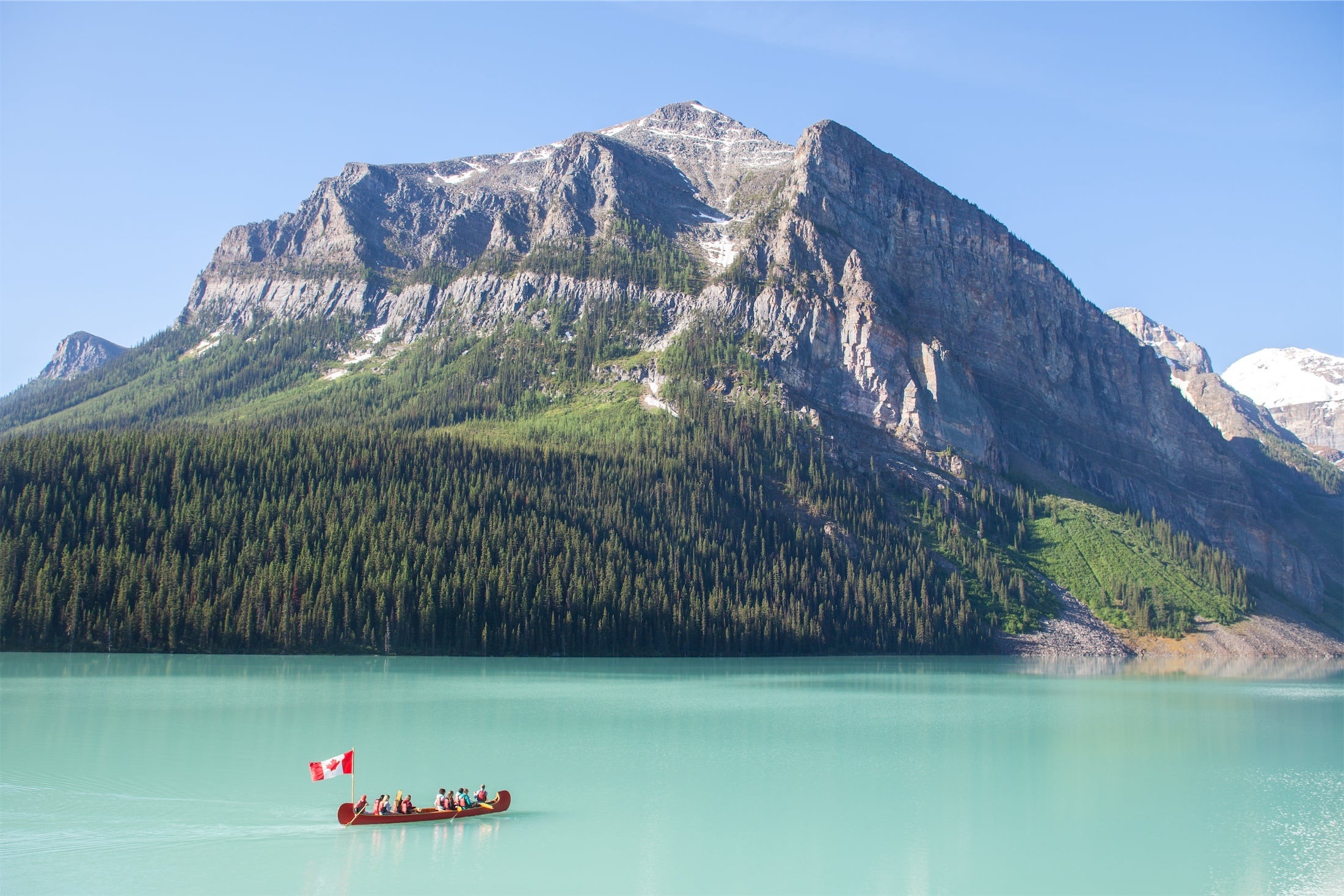 Turquoise Lake Louise beneath mountain peaks