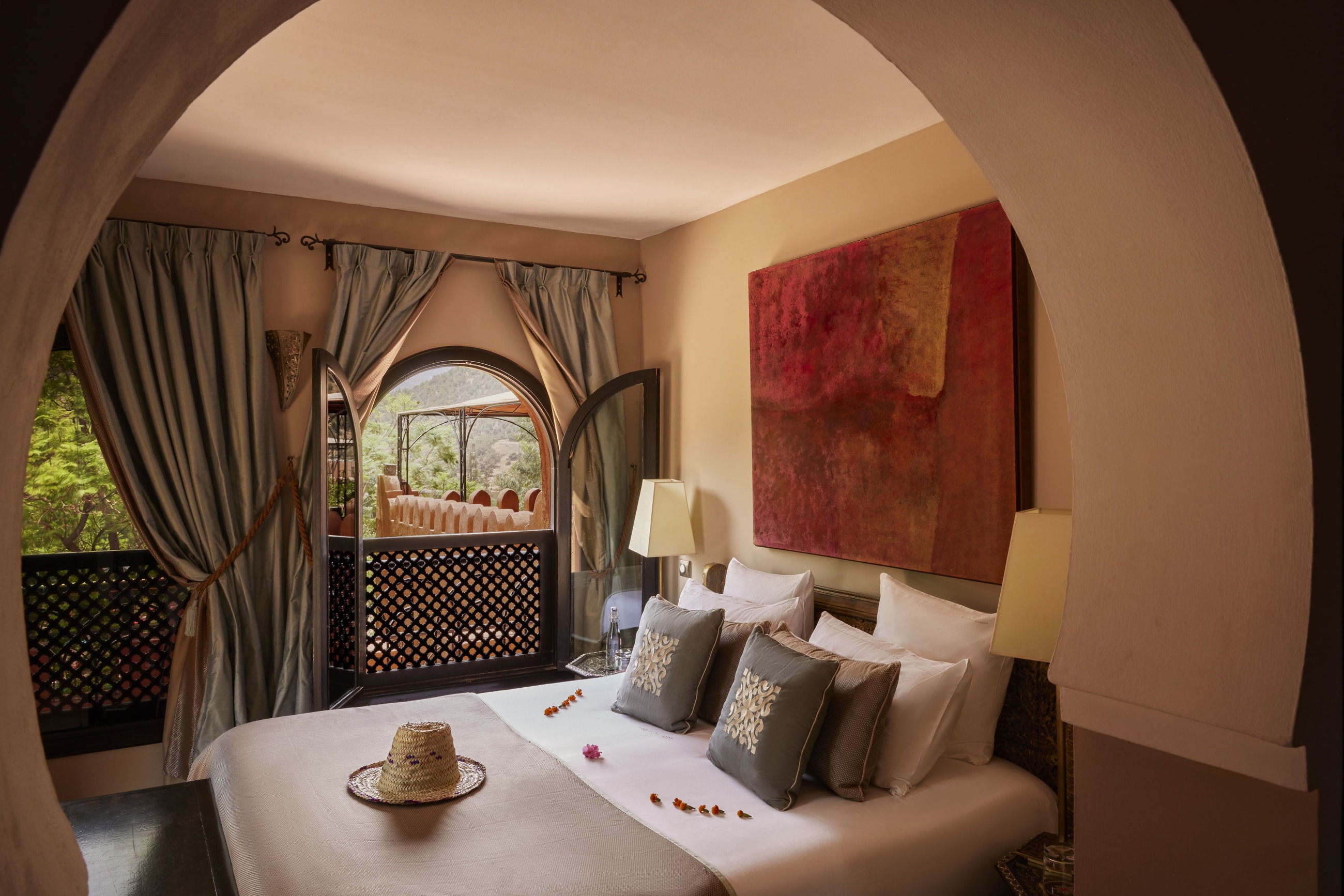 Suite with arched doorway and sitting area at Kasbah Tamadot, Atlas Mountains, Morocco