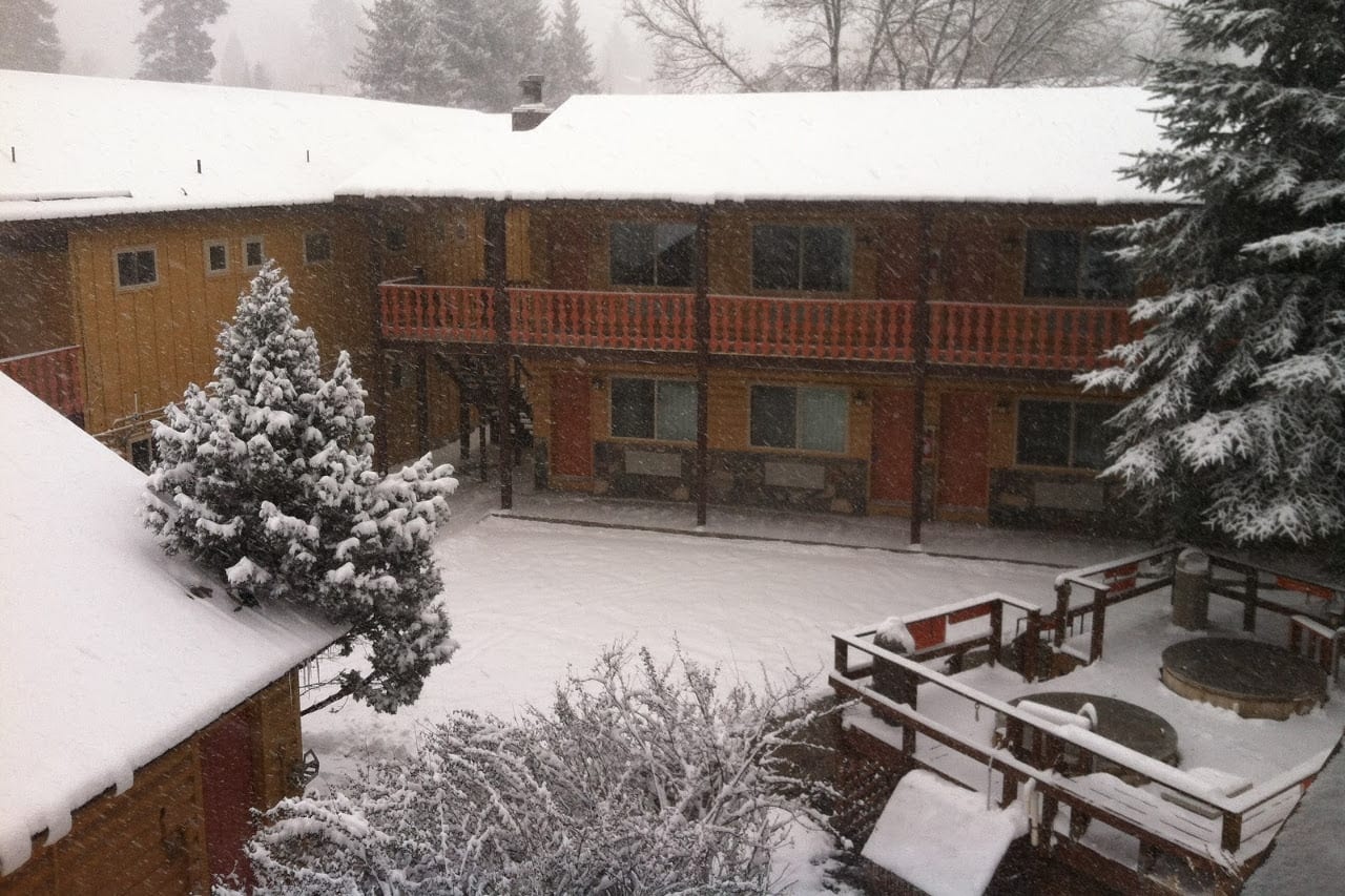 Snow-covered lodge courtyard and balconies at Box Canyon Lodge & Hot Springs, Ouray, USA