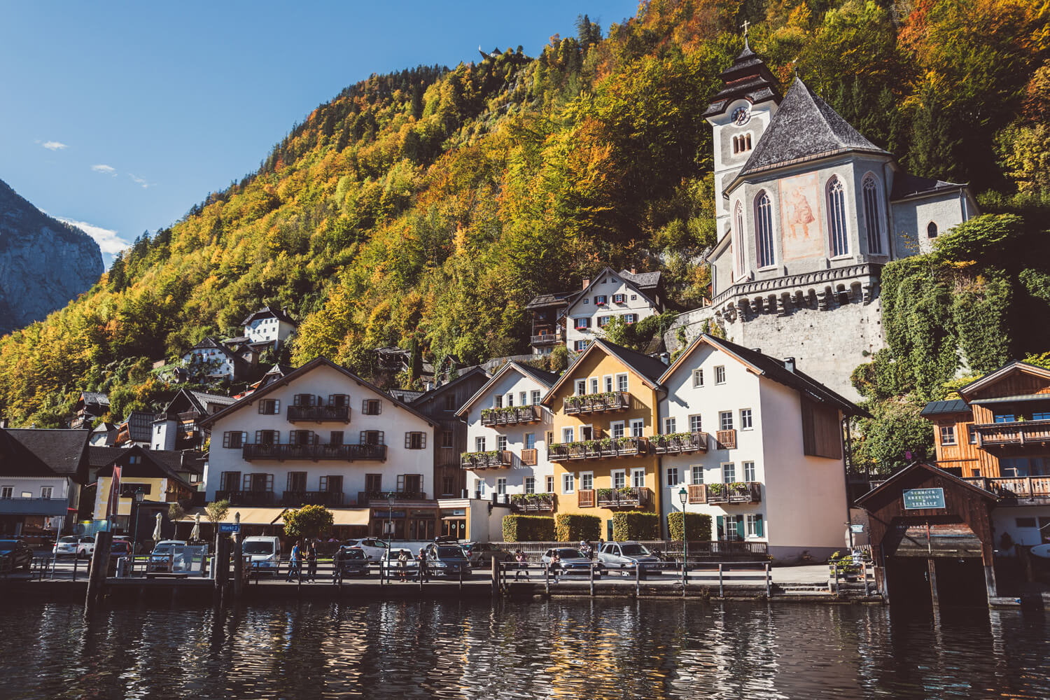 Lakeside exterior of Heritage Hotel Hallstatt's Kainz house beneath the hillside church