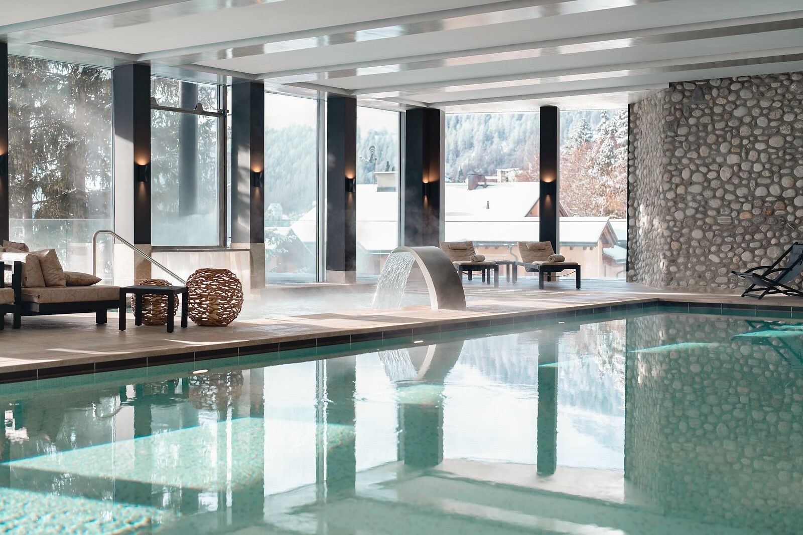 Indoor spa pool with loungers and large windows facing the snow, Carlton Hotel St. Moritz, St. Moritz, Switzerland