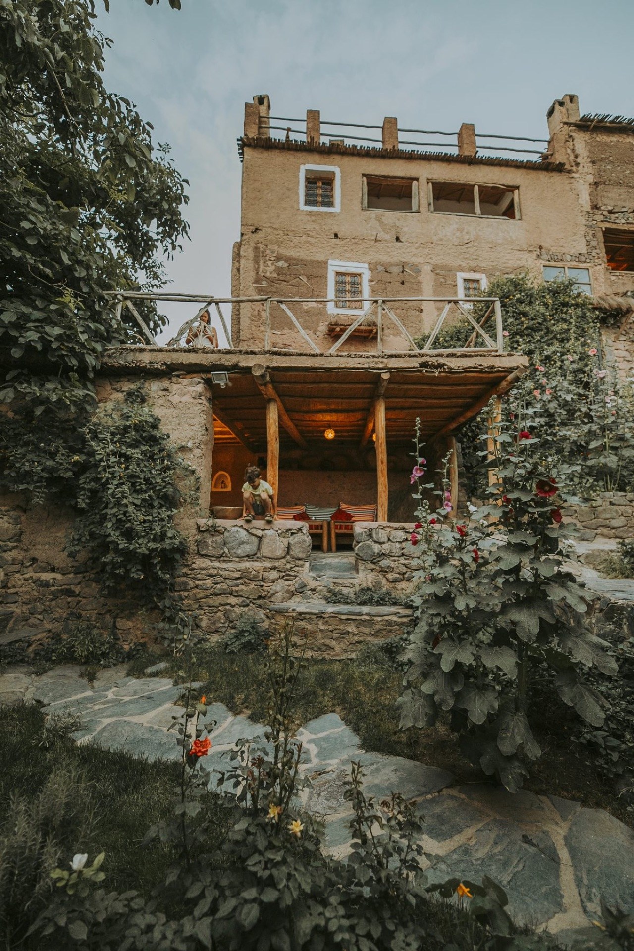 Earth-coloured facade and garden path at Douar Samra