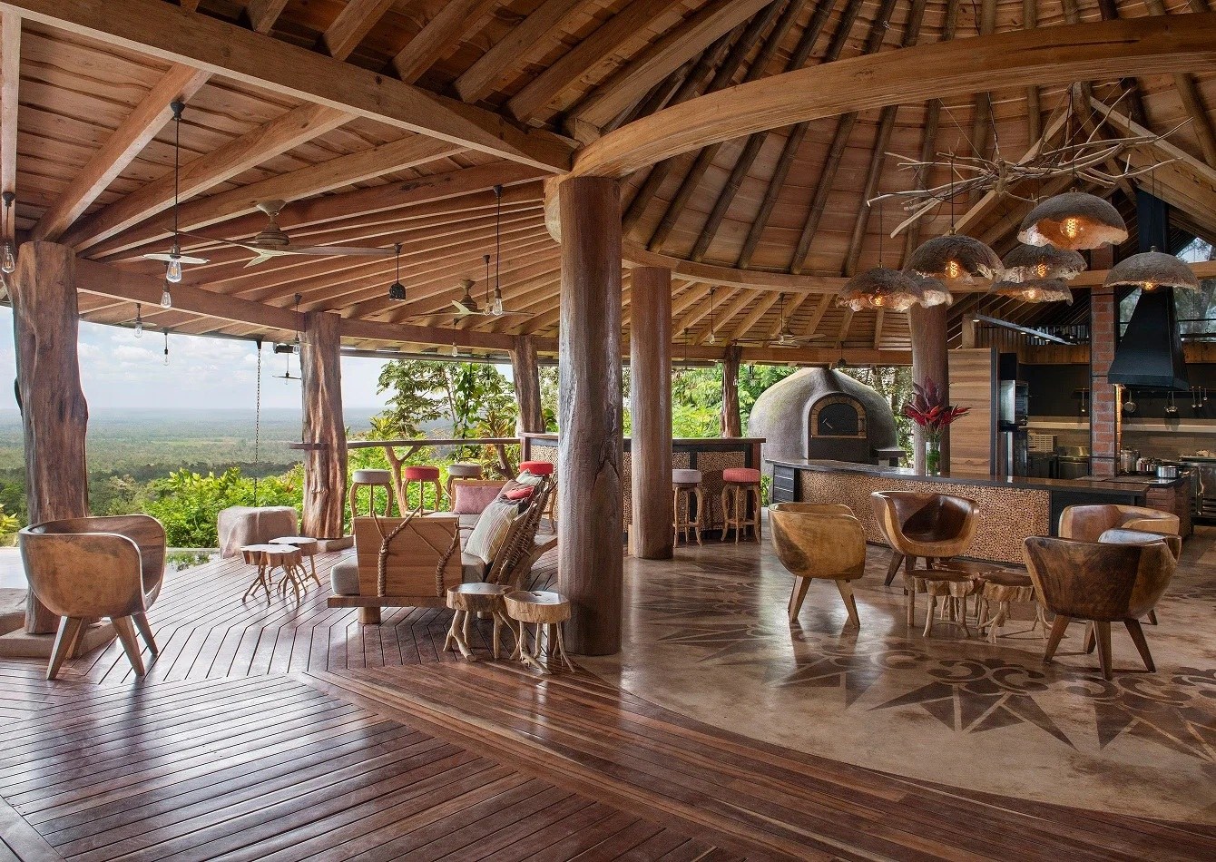 Open-sided restaurant with wooden furniture and panoramic valley views, Origins Luxury Lodge