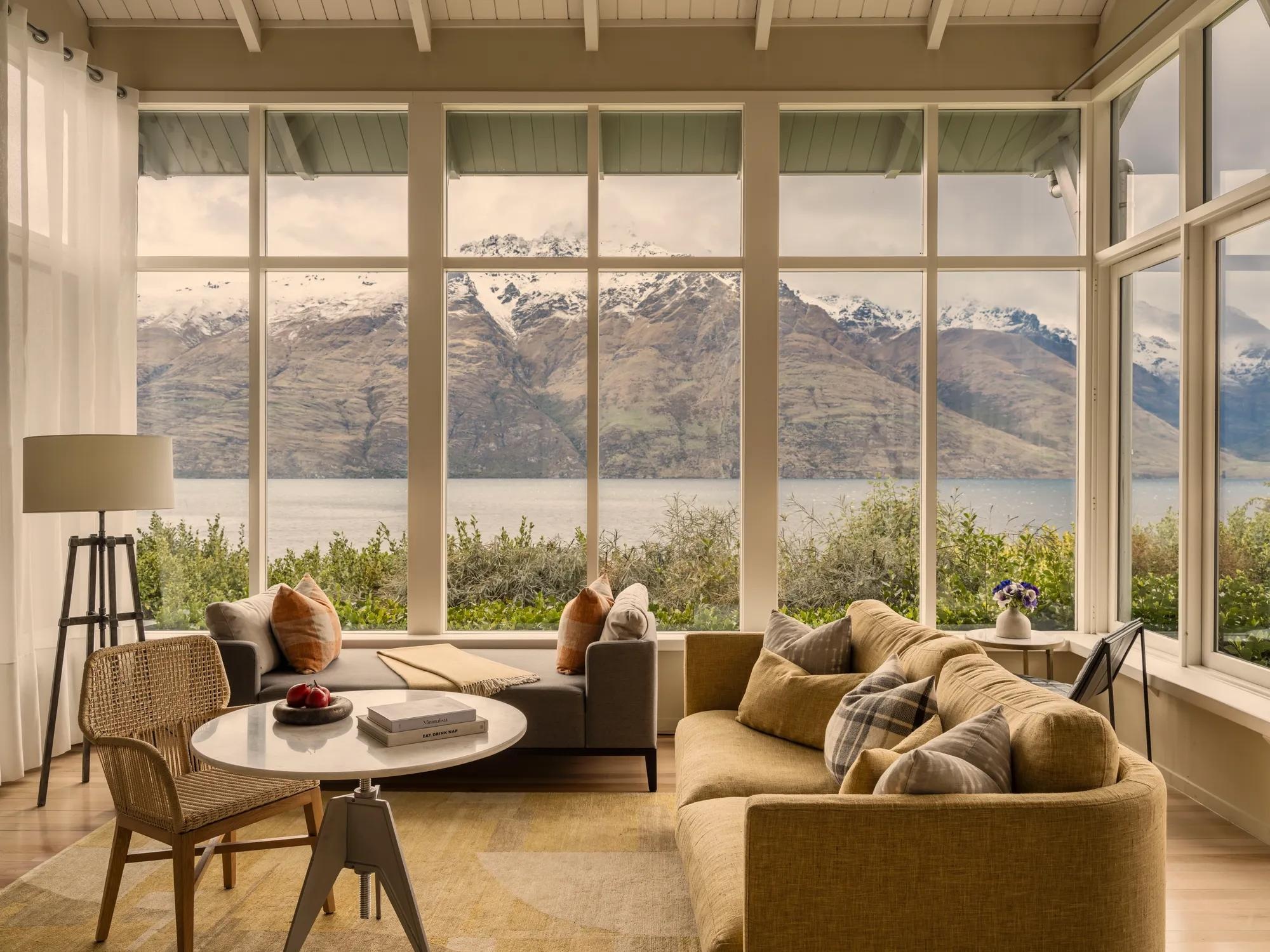 Suite sitting area with lake and mountain views at Matakauri Lodge, Queenstown, New Zealand