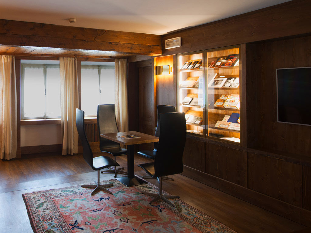 Cigar lounge with leather armchairs, Hotel de la Poste, Cortina d’Ampezzo, Italy