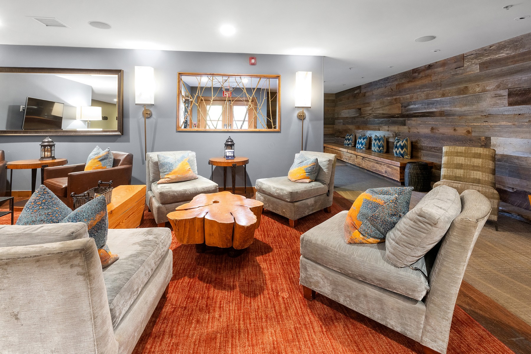 Sofas, wood-panelled walls and tables in the lounge at The Osprey at Beaver Creek.