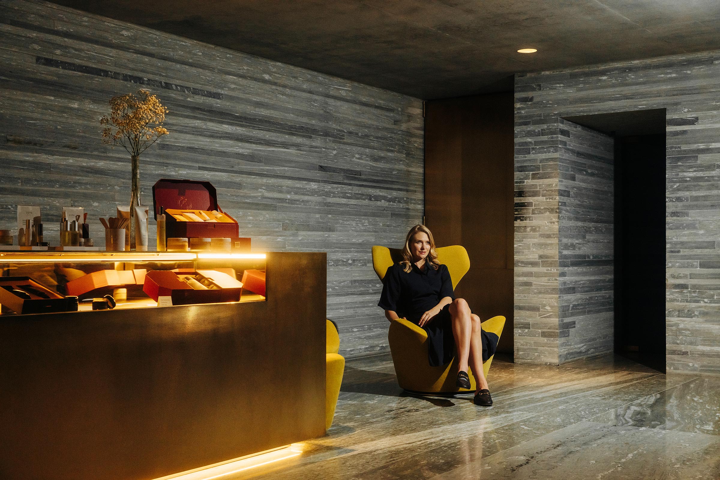 Stone-lined spa reception with an illuminated curved desk at 7132 Hotel, Vals, Switzerland