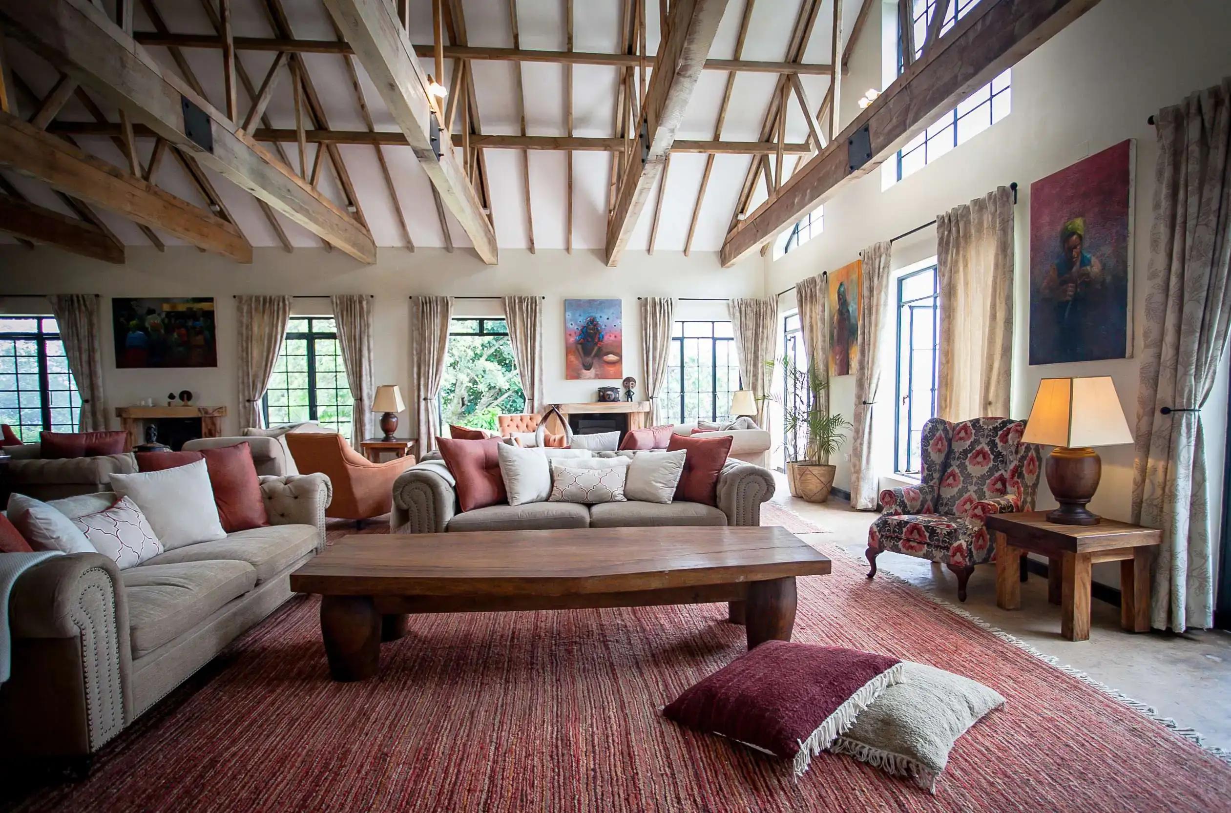 Bright lounge with sofas beneath a vaulted timber ceiling, Clouds Mountain Gorilla Lodge, Bwindi Impenetrable National Park, Uganda