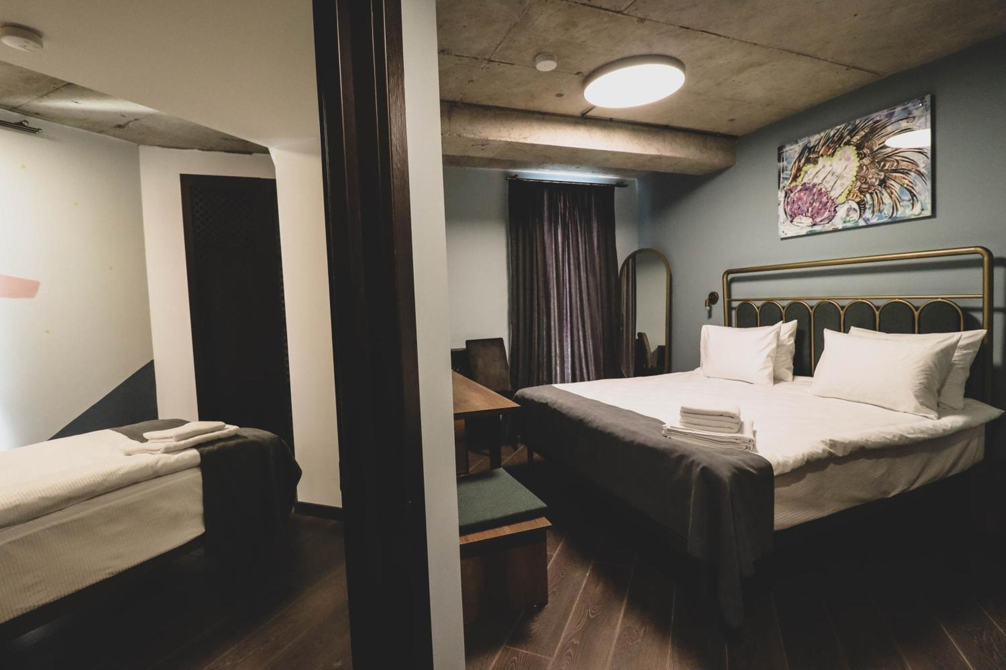 Guest bedroom with a double bed and mirrored wardrobe at Paliani Hotel, Mestia, Georgia
