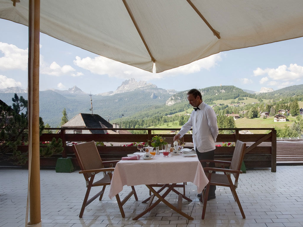 Outdoor terrace with mountain views, Hotel de la Poste, Cortina d’Ampezzo, Italy