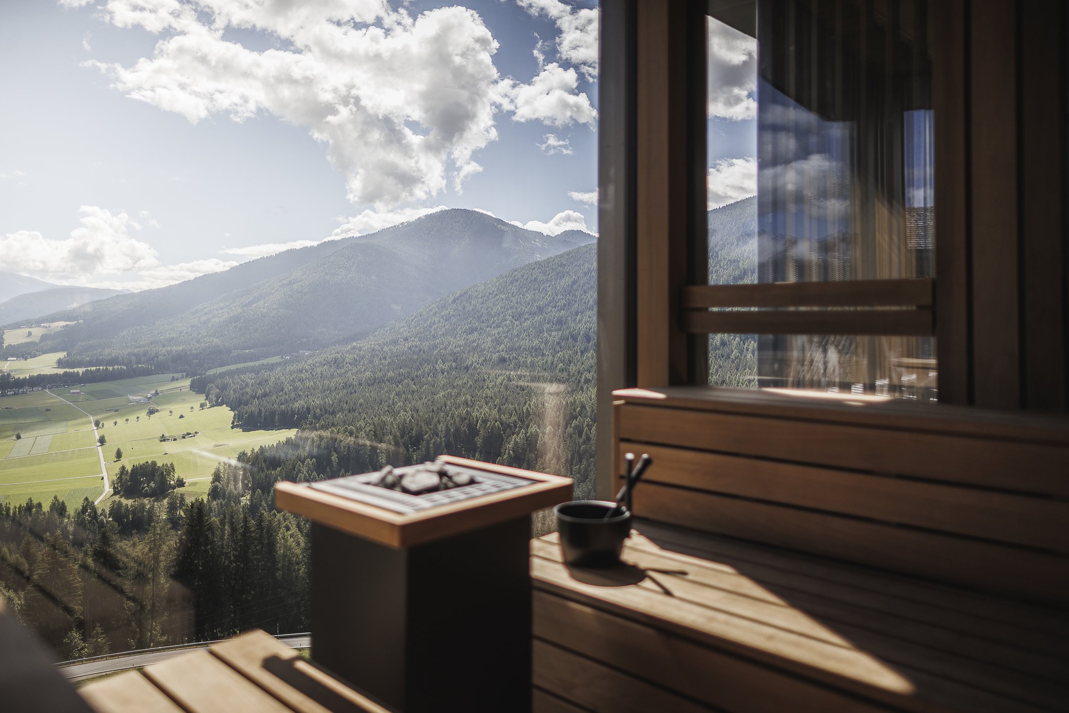 Sauna window framing South Tyrolean mountains at Alpin Panorama Hotel Hubertus, Olang, Italy
