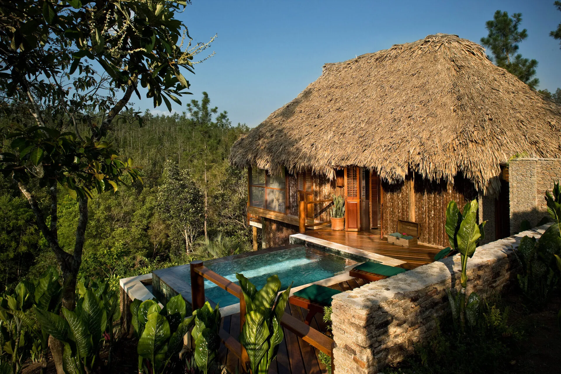 Private plunge pool beside a thatched cottage, Blancaneaux Lodge, Mountain Pine Ridge, Cayo, Belize