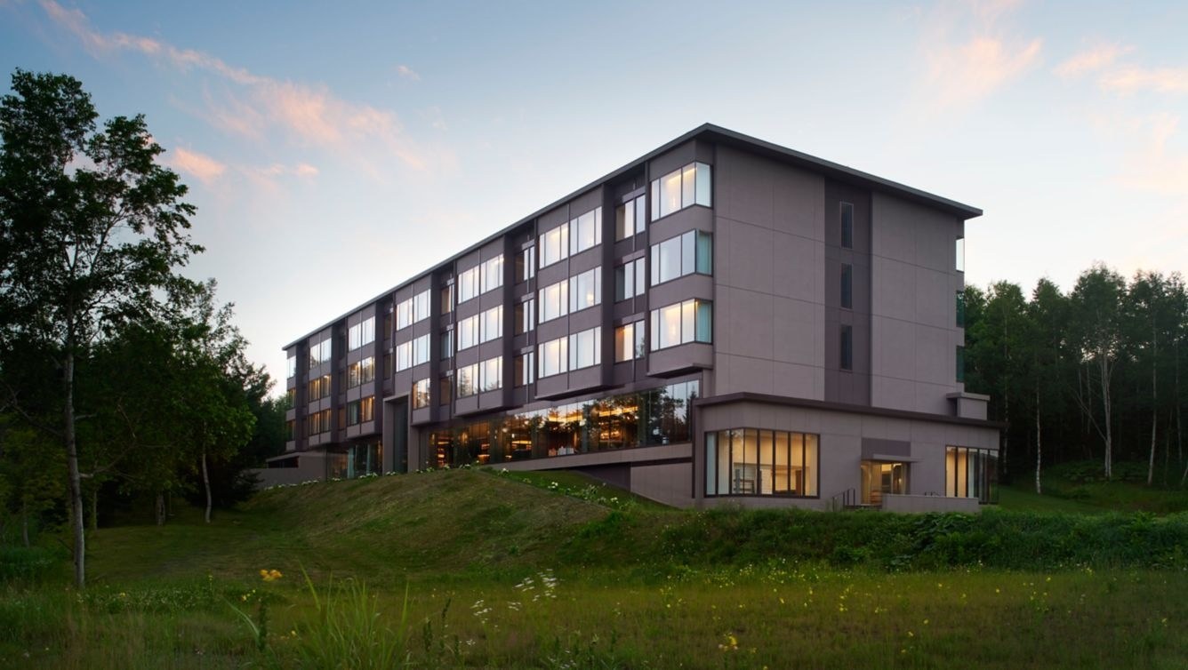 Hotel exterior in the green season, with a lawn and landscaped planting beside the entrance, Higashiyama Niseko Village, a Ritz-Carlton Reserve