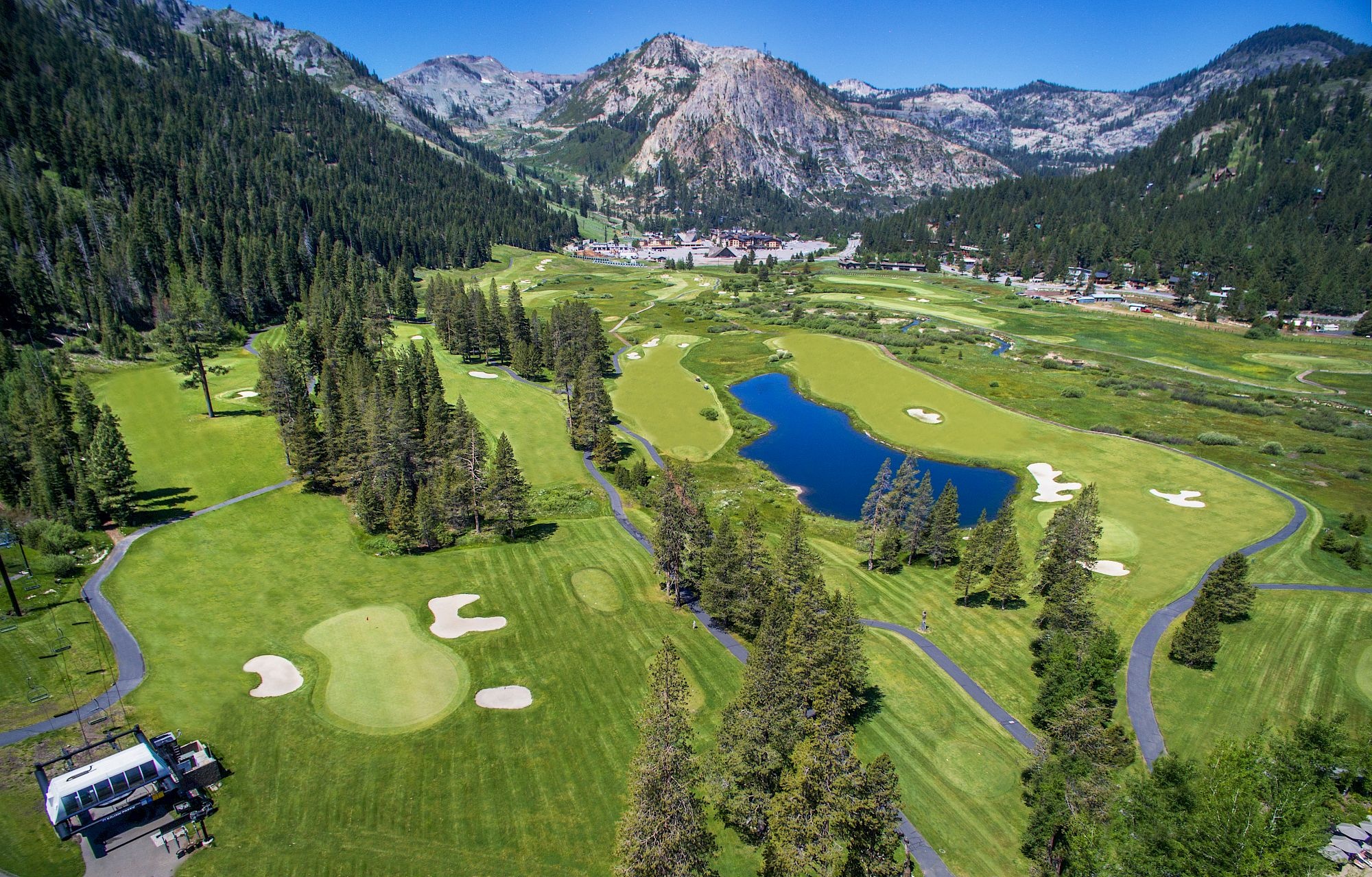 Resort golf course, pond, and surrounding mountain landscape at Everline Resort & Spa, Palisades Tahoe, USA