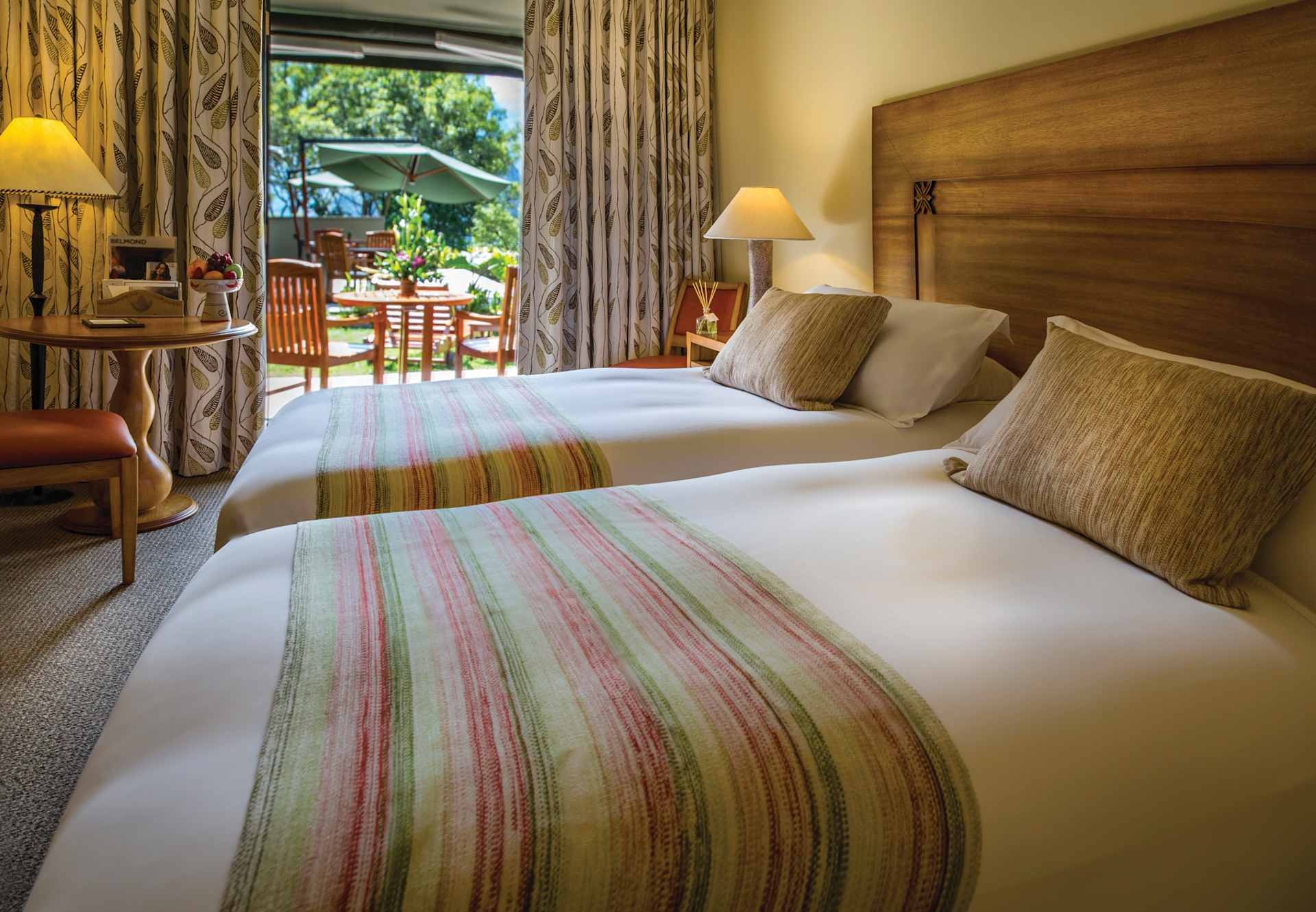 Twin guest room opening onto a garden terrace at Belmond Sanctuary Lodge, Machu Picchu, Peru