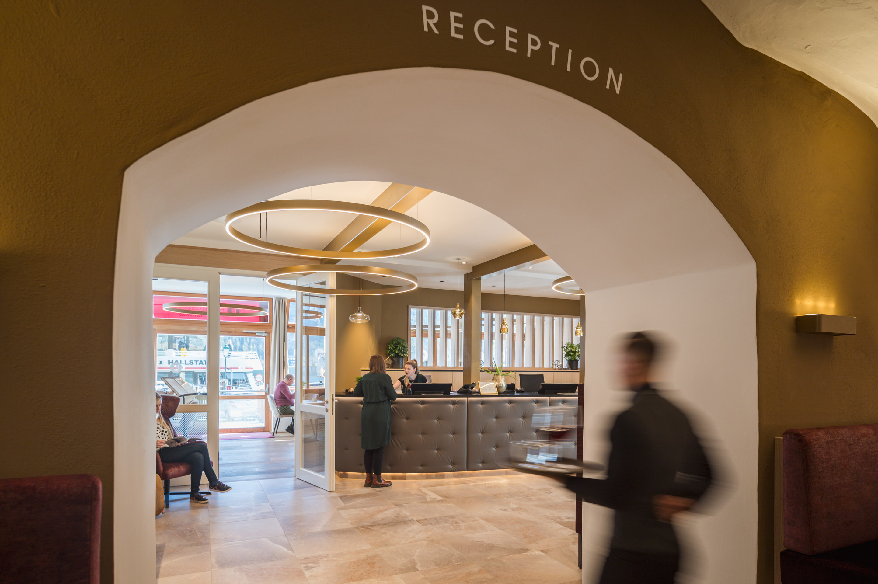 Reception area in Heritage Hotel Hallstatt's Kainz house, with an arched entrance and circular lights