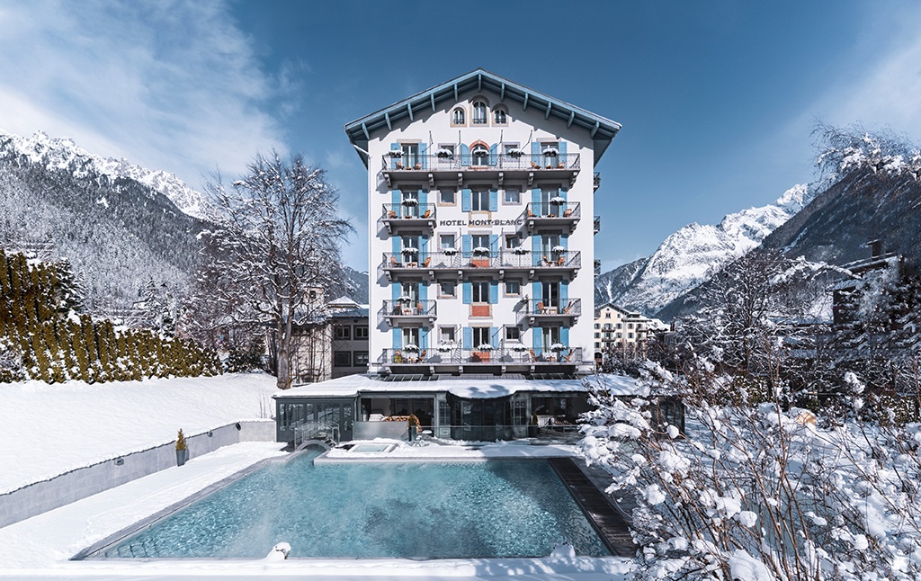 Chamonix facade beside its heated outdoor pool at Hôtel Mont-Blanc, Chamonix, France
