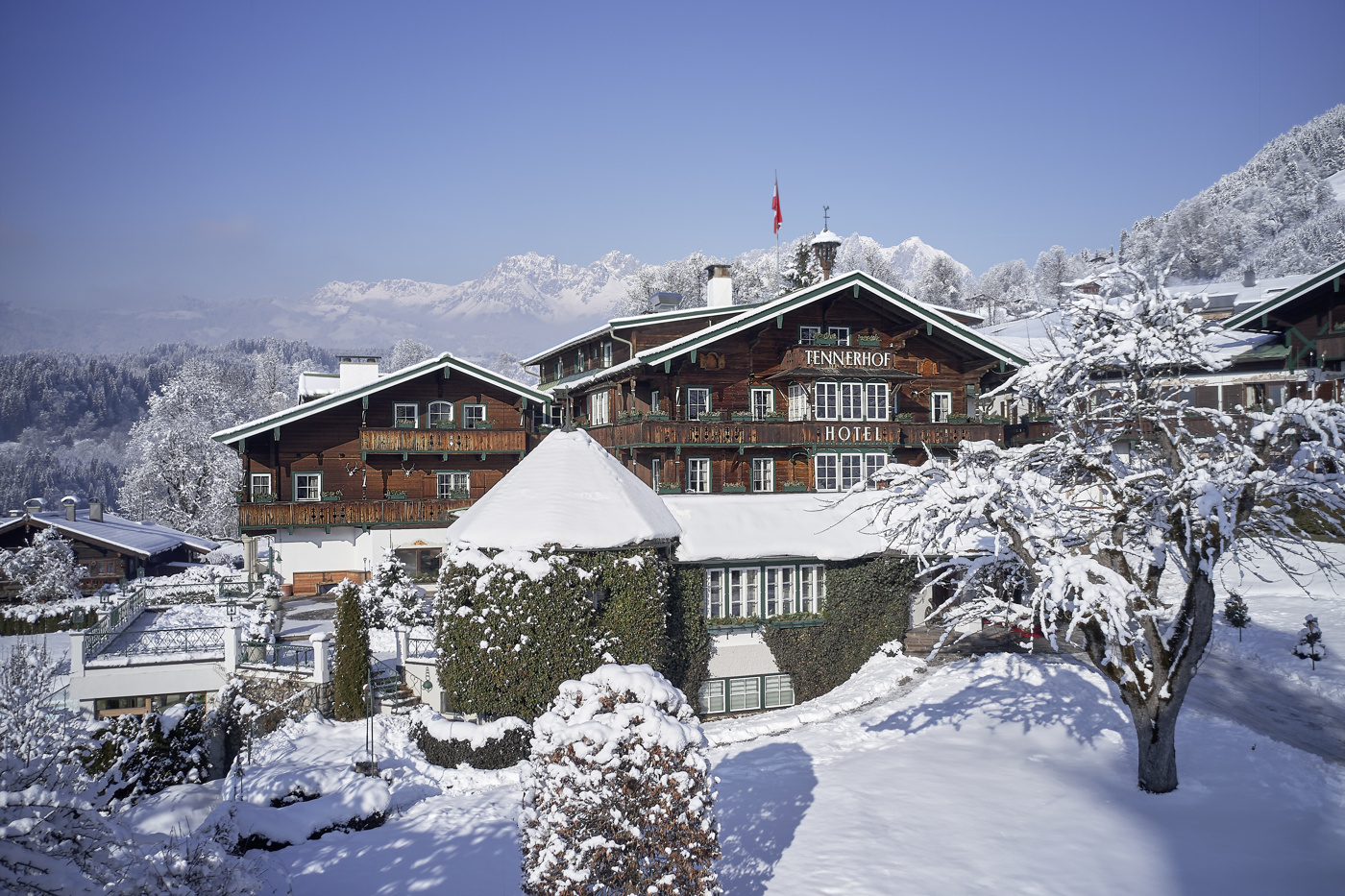 Snow-covered hotel exterior in its Alpine setting, Tennerhof, Kitzbühel, Austria