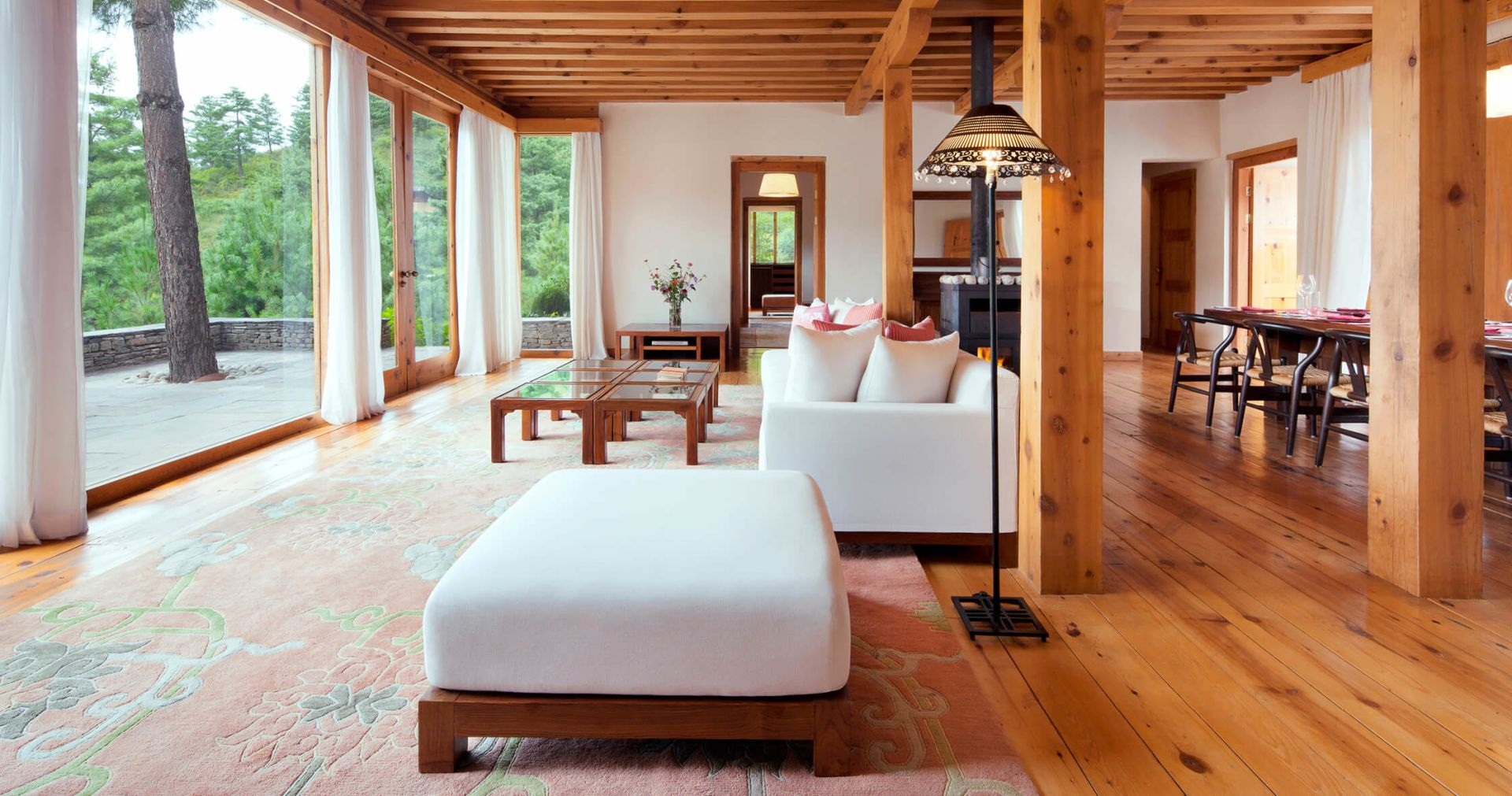 Villa living room with timber ceilings and forest views at COMO Uma Paro, Paro, Bhutan