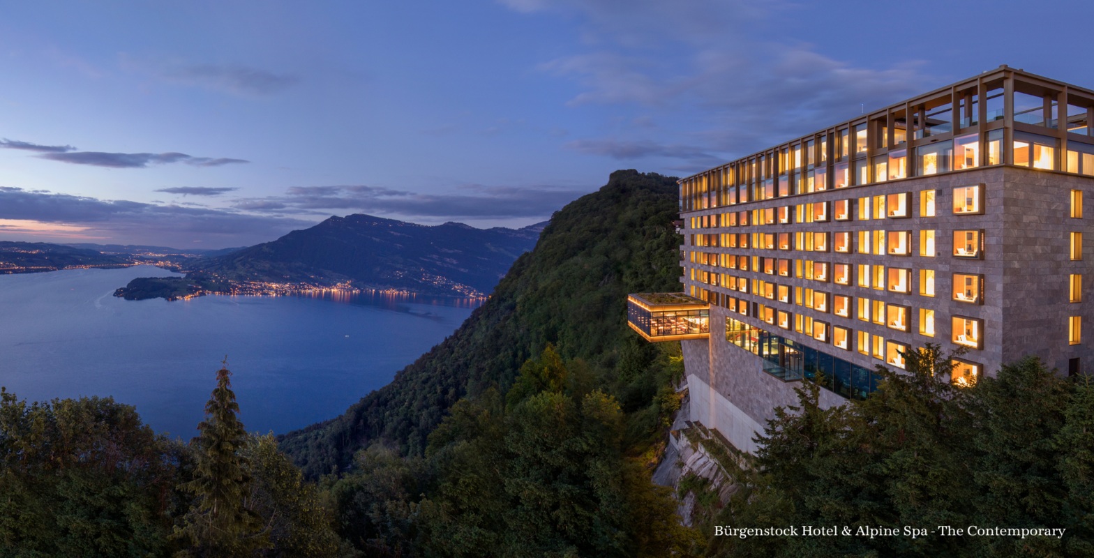 Hotel exterior above the lake with mountains at Bürgenstock Resort, Lake Lucerne, Switzerland