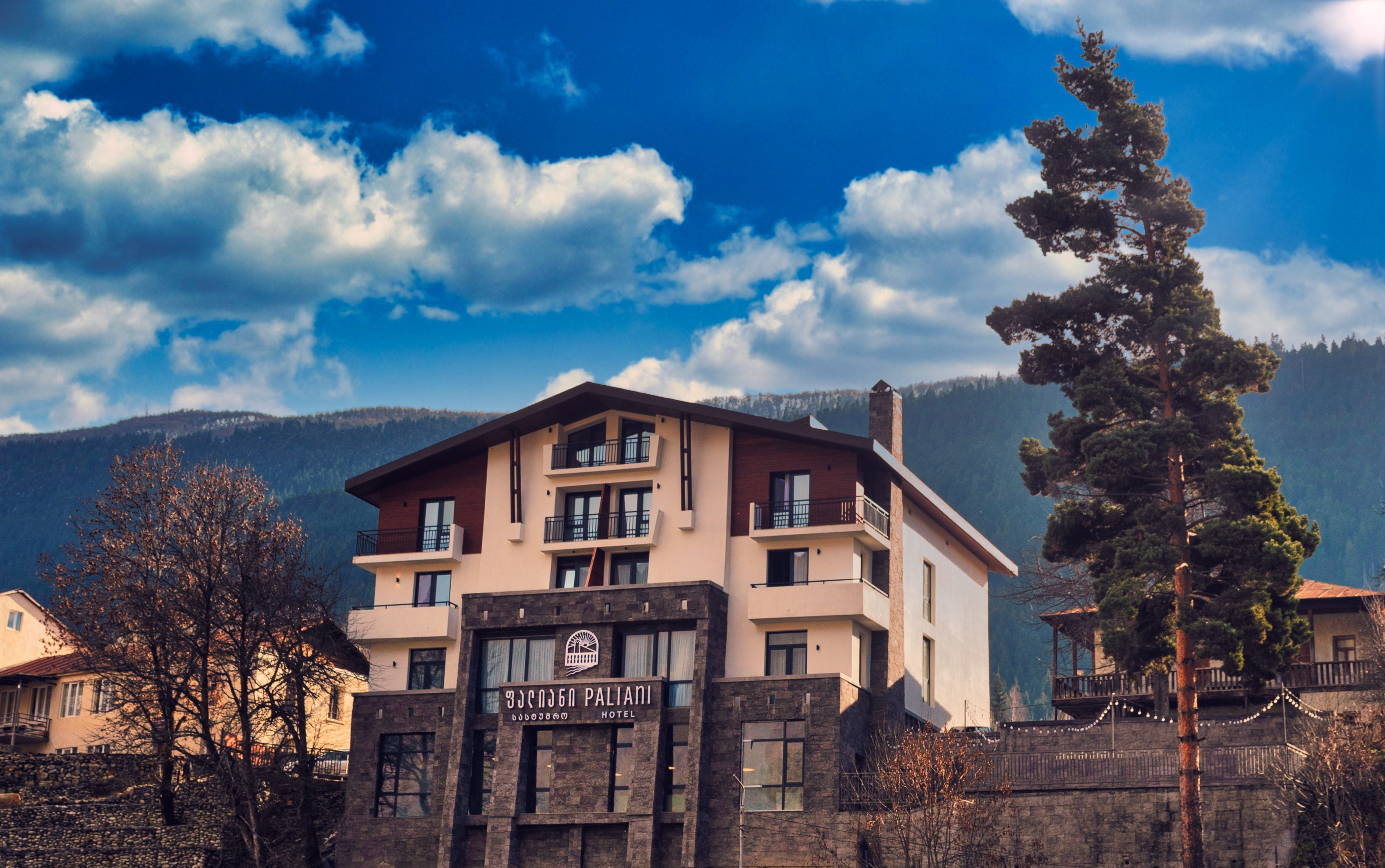 Paliani Hotel exterior in daylight with mountains behind, Mestia, Georgia