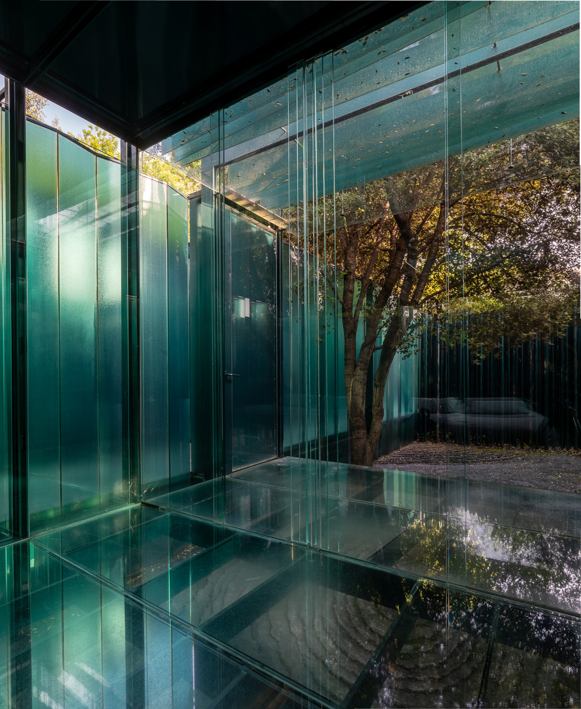A pavilion interior looking out to the surrounding greenery at Les Cols Pavellons, Olot, Spain
