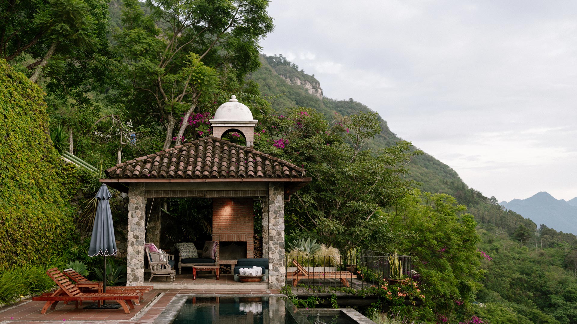 Pool beside a tiled-roof pavilion in the wooded hillside, Casa Palopó, Lake Atitlán, Guatemala