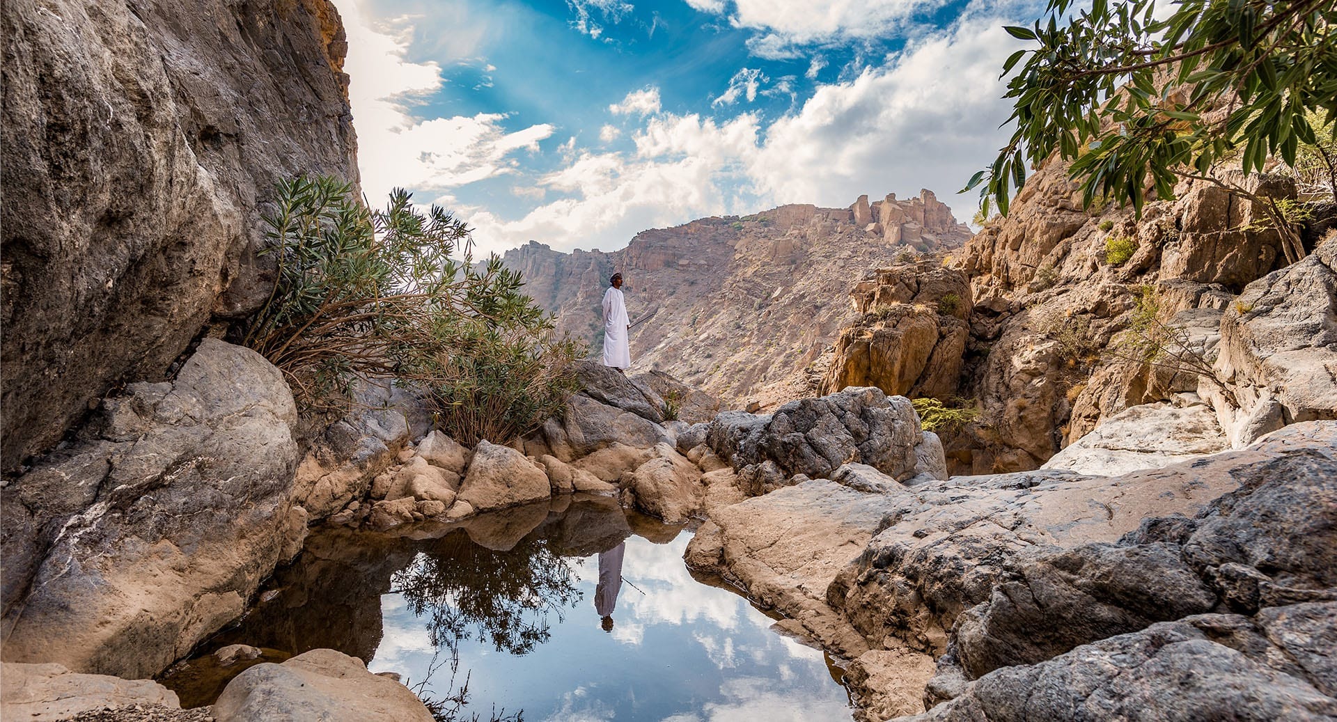 Rocky canyon pool and distant waterfall, Anantara Al Jabal Al Akhdar, Jebel Akhdar, Oman