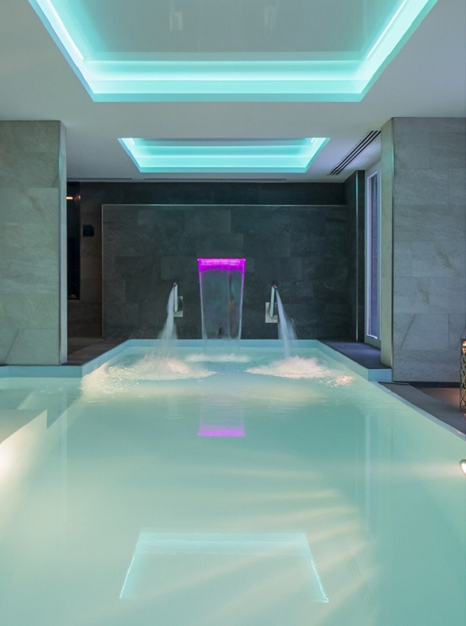 Indoor spa swimming pool with softly illuminated walls, Grand Hôtel des Alpes, Chamonix, France