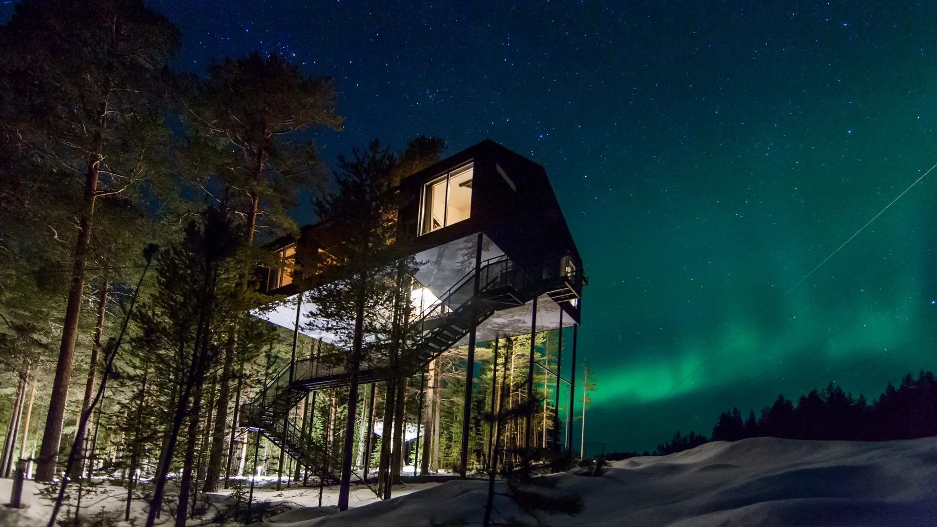 The 7th Room treehouse beneath the northern lights at Treehotel, Harads, Swedish Lapland
